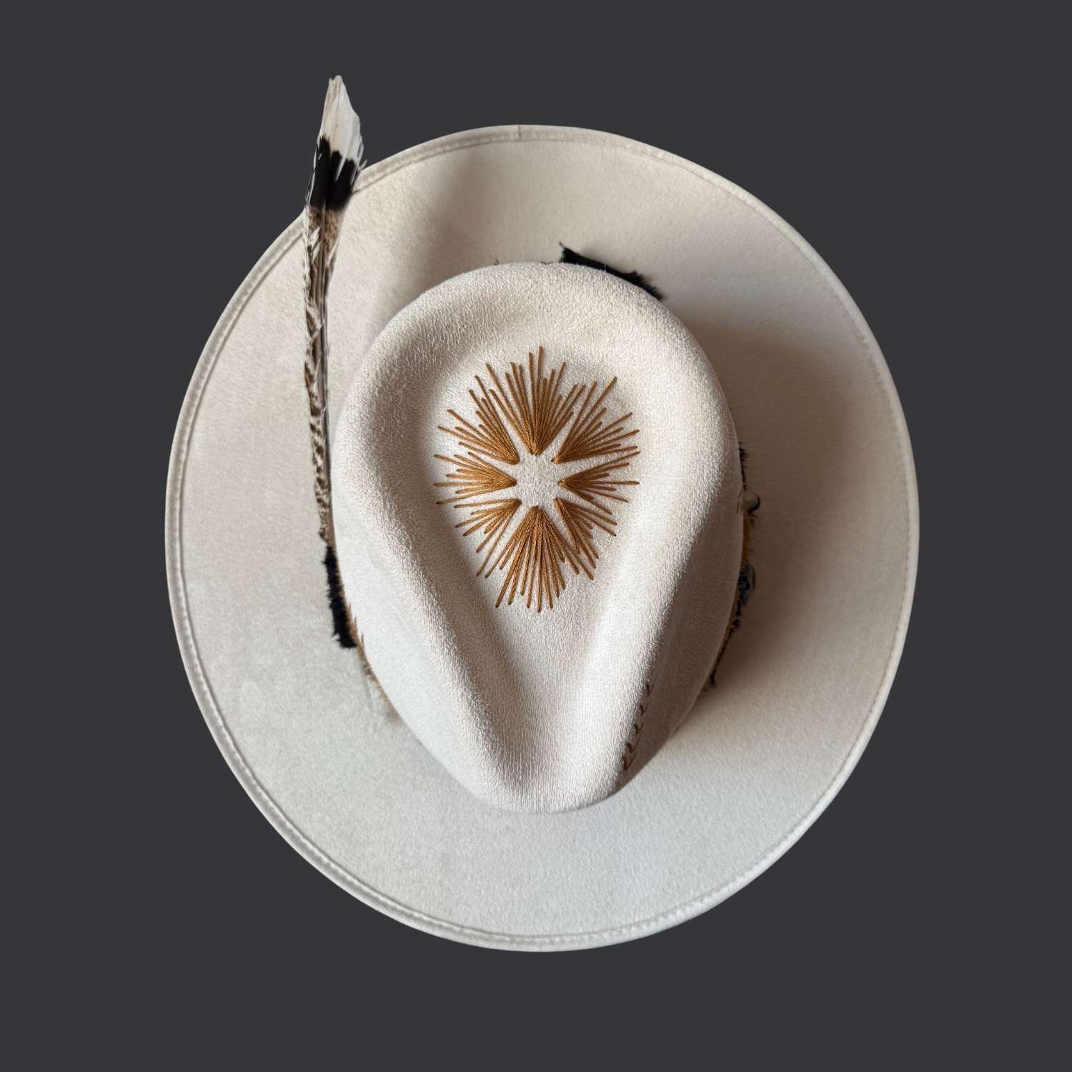 Top view of ivory wide-brim hat with sunburst embroidery on crown