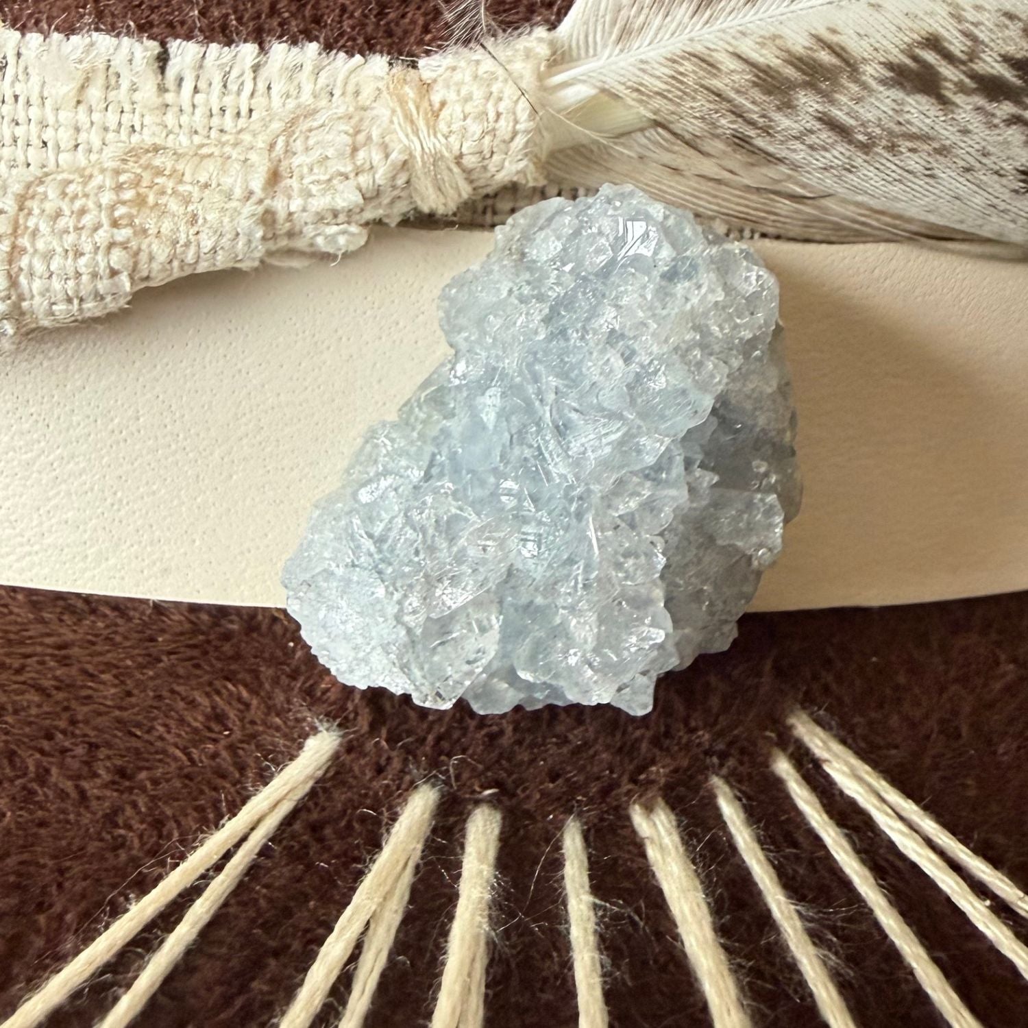 Brown wide brim fedora with celestite crystal and hand embroidered sunburst design / close up of crystal