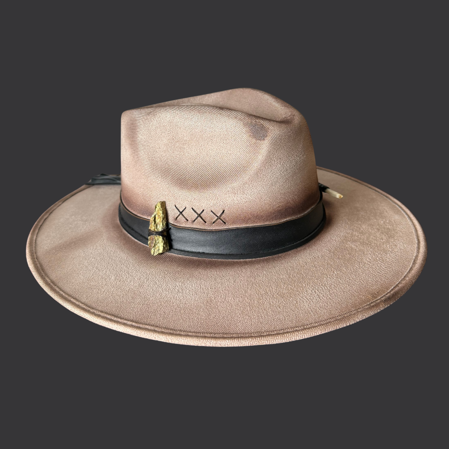 Left side view of khaki wide-brim fedora hat with chalcopyrite crystal and black leather tassels
