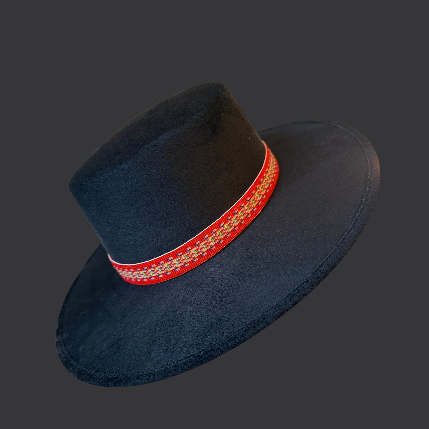 Black cordobés hat with Red River Métis beaded sash by Winnipeg Métis artist, honoring waterways, ancestry, and resilience / agled front view