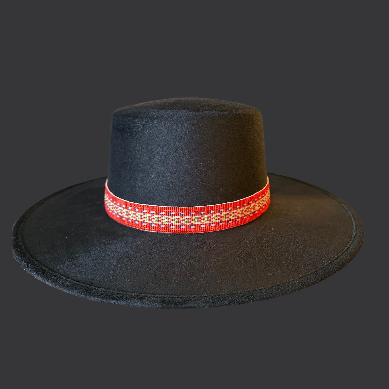 Black cordobés hat with Red River Métis beaded sash by Winnipeg Métis artist, honoring waterways, ancestry, and resilience / front view