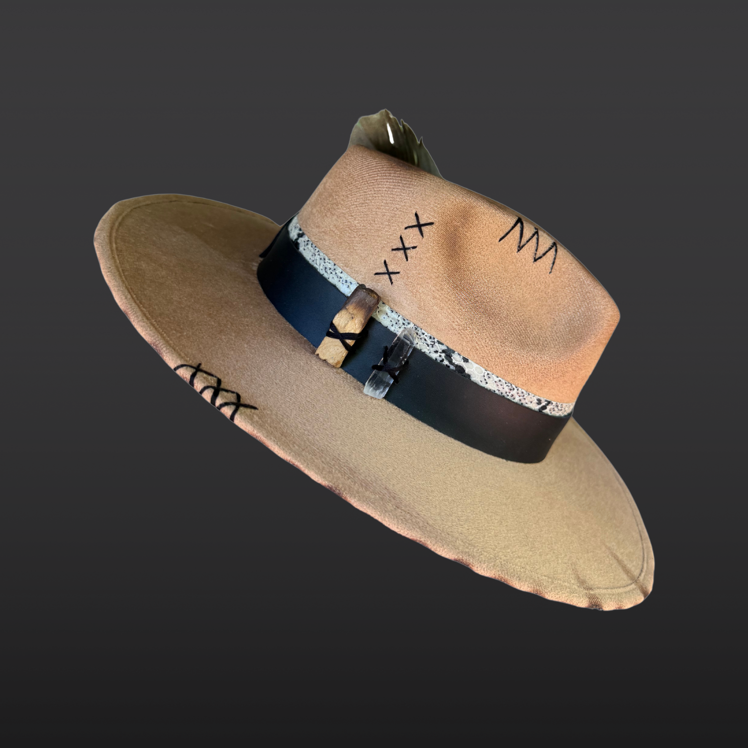 Right side view of Transmutation fedora highlighting clear quartz crystal, burnt palo santo, turkey feather, and layered leather bands.