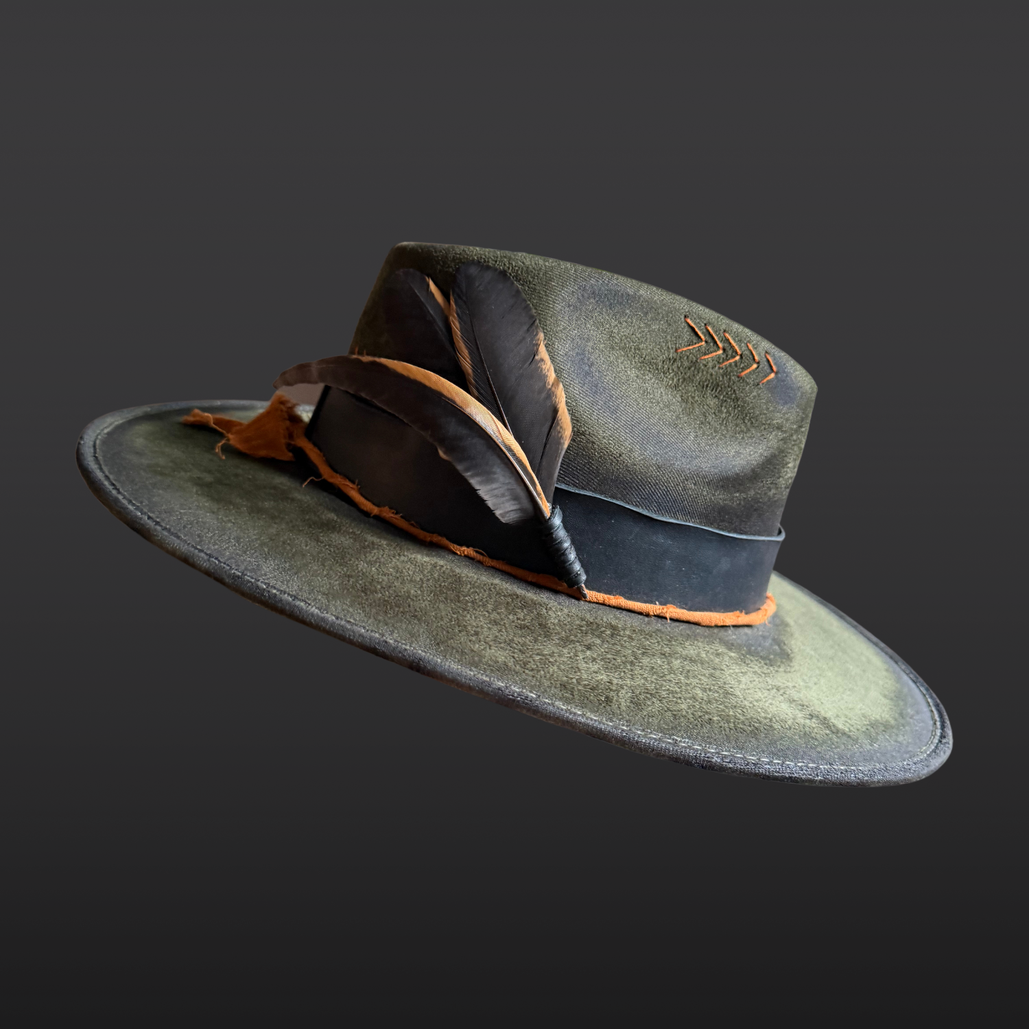 Close up of rooster feathers on the Solar Path Fedora Hat showcasing hand-torched vegan suede texture and organic patterns.