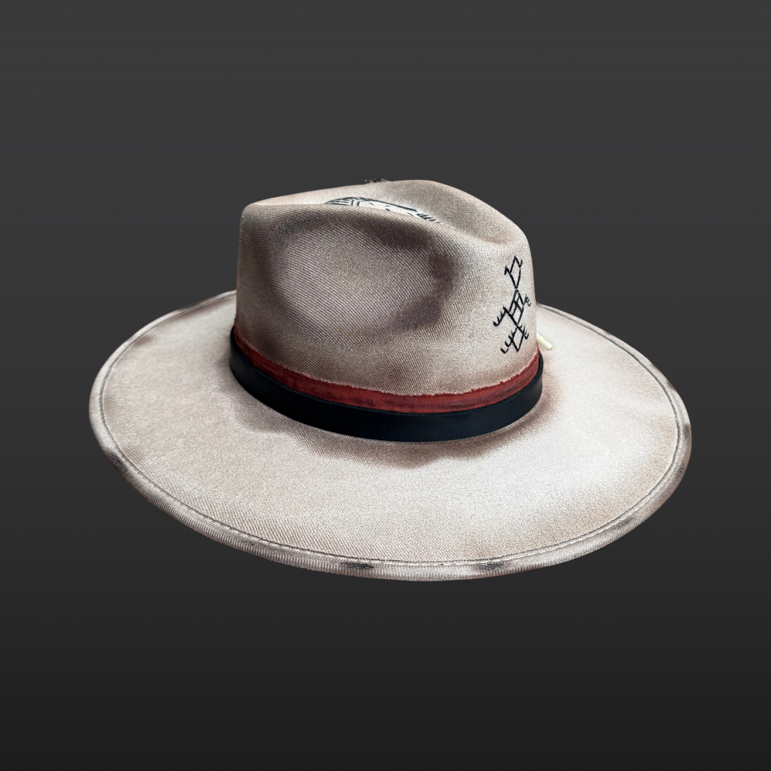 Left side view of Ember Guardian wide brim fedora hat showing pyrite crystal, turkey feather, and symbolic embroidery details.