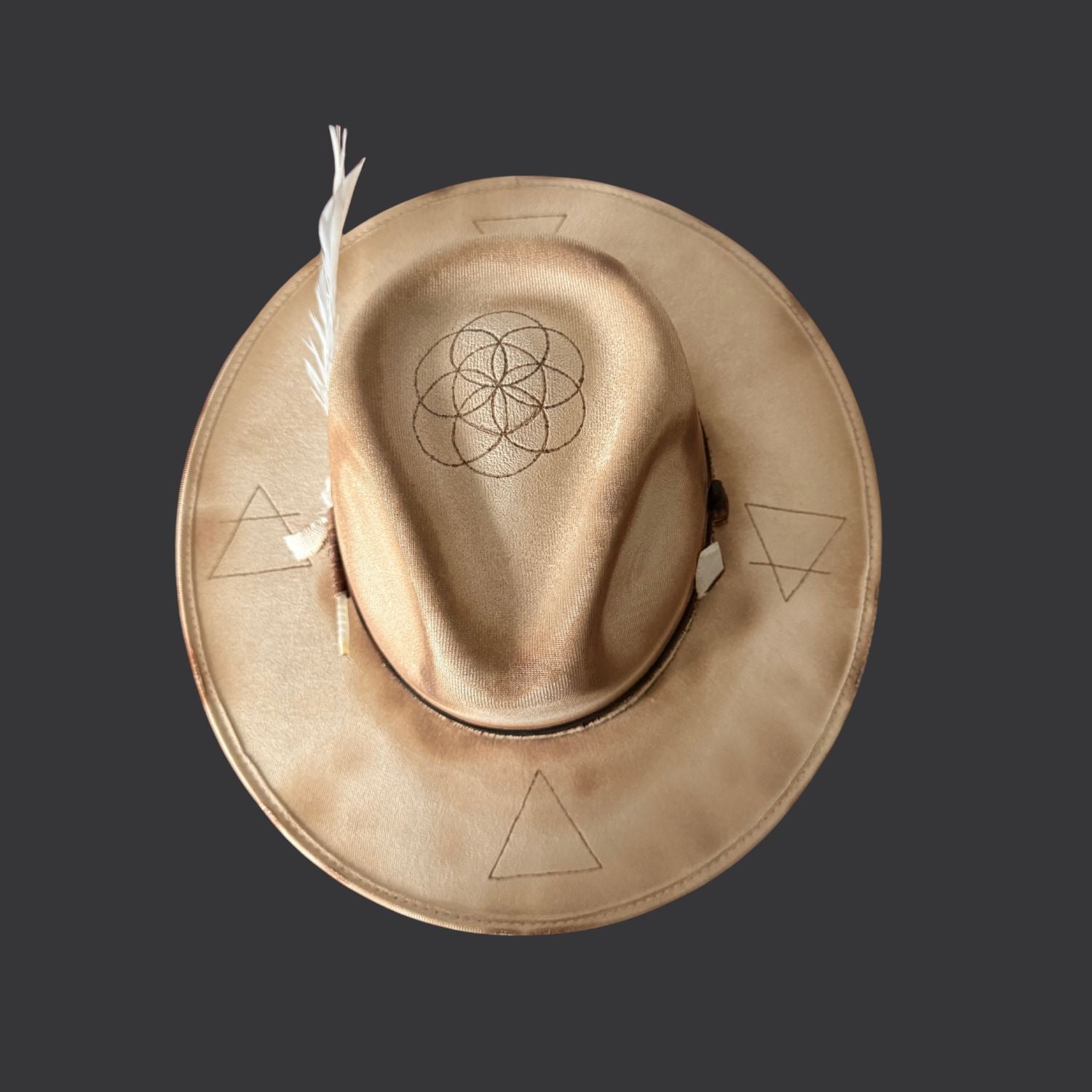 Cream wide-brim vegan suede fedora with Seed of Life and Four Elements pyrography, brown leather band, feather, and crystal arrow / alternate top view
