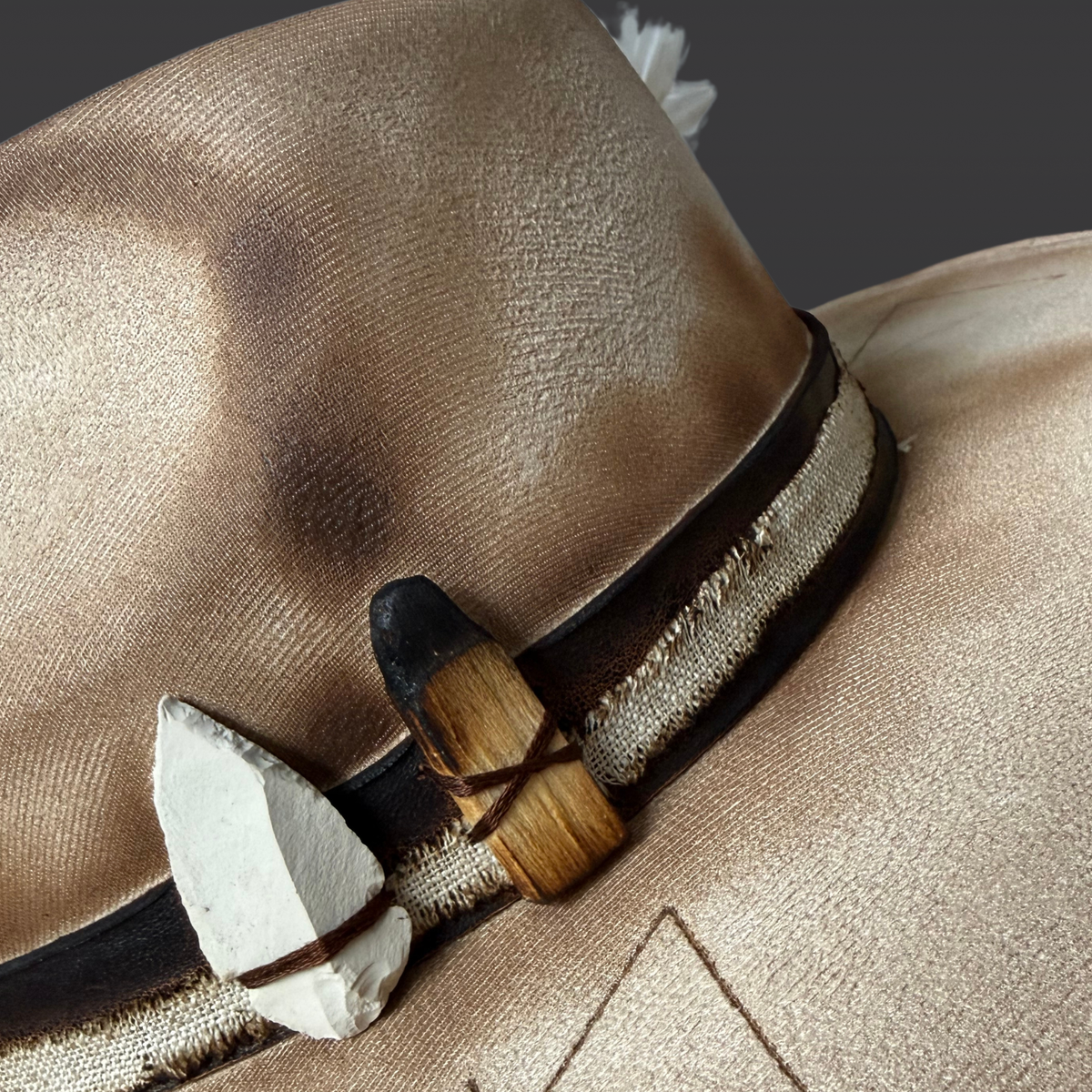 Close-up of zeolite crystal arrow and palo Santo on Elemental Harmony fedora