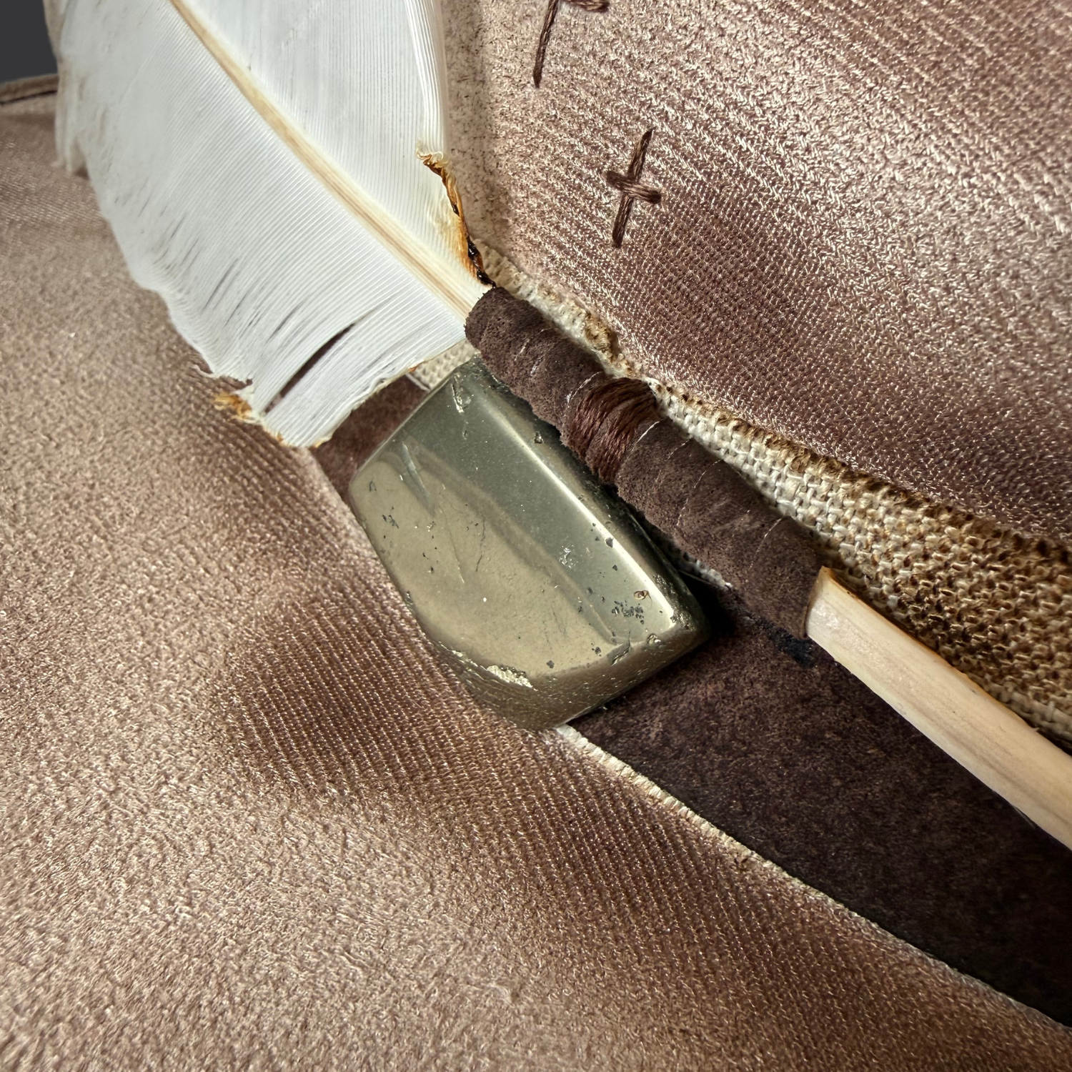 Close-up of pyrite stone on khaki fedora hat