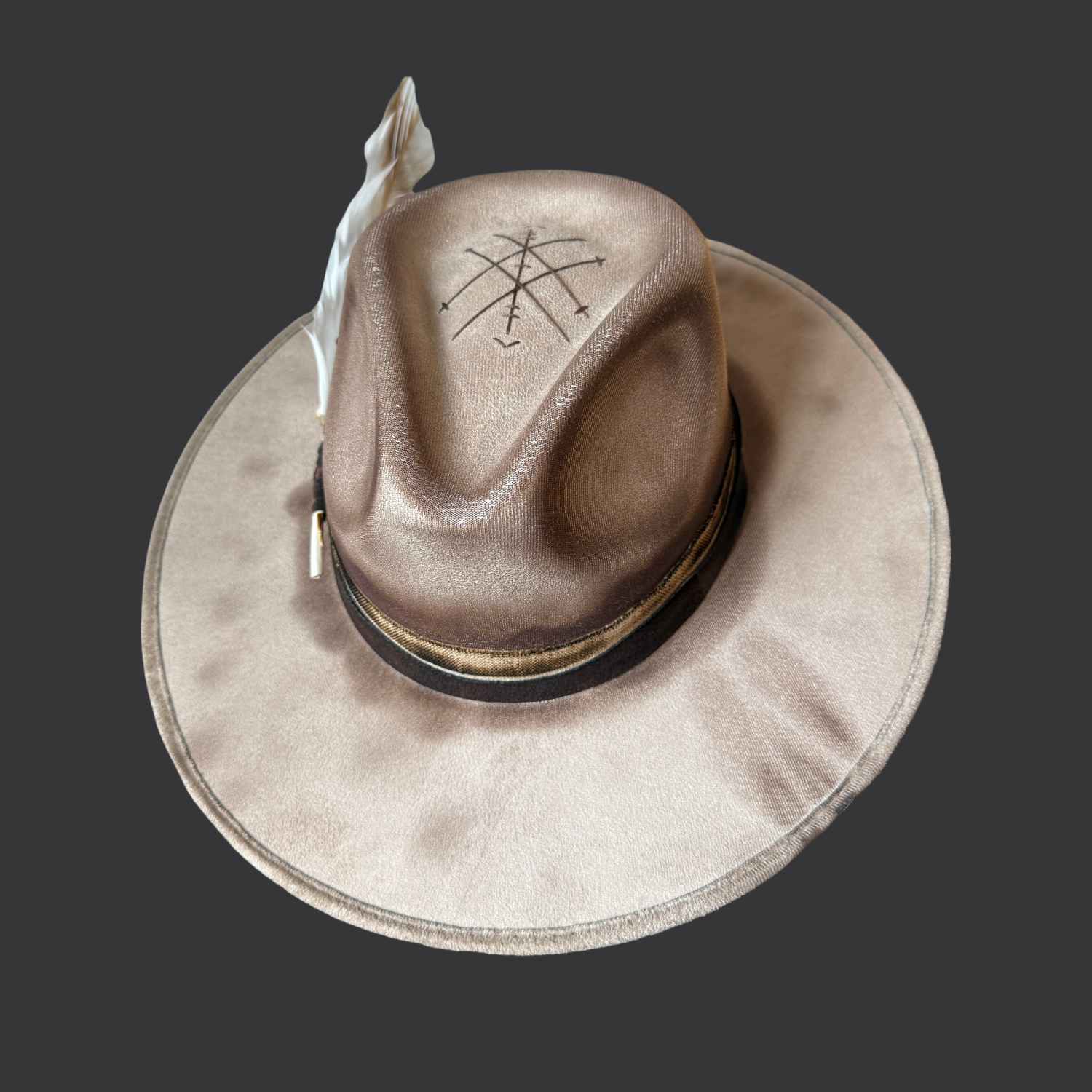 top view of khaki fedora hat with pyrography detailing and pyrite accent