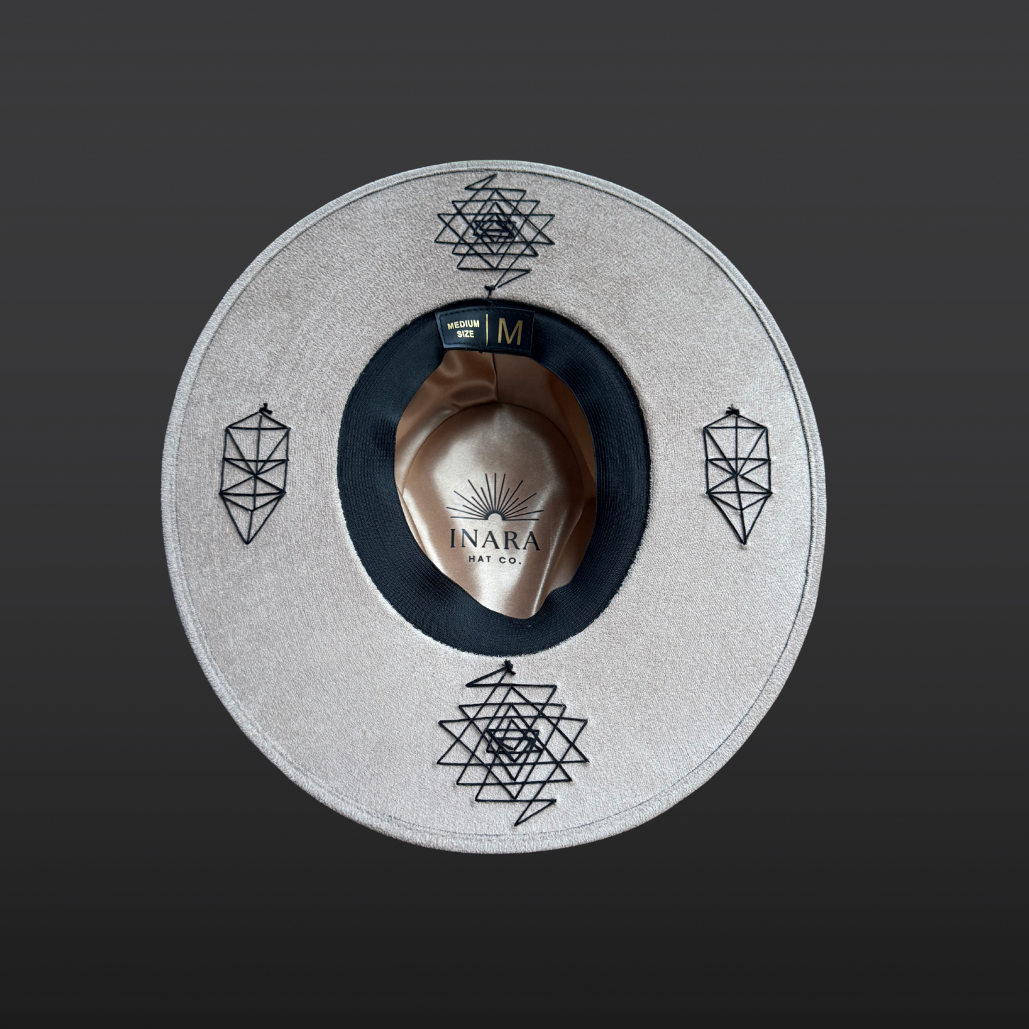 Underside view of Rooted Light fedora displaying hand embroidered Sri Yantra symbol beneath the brim.