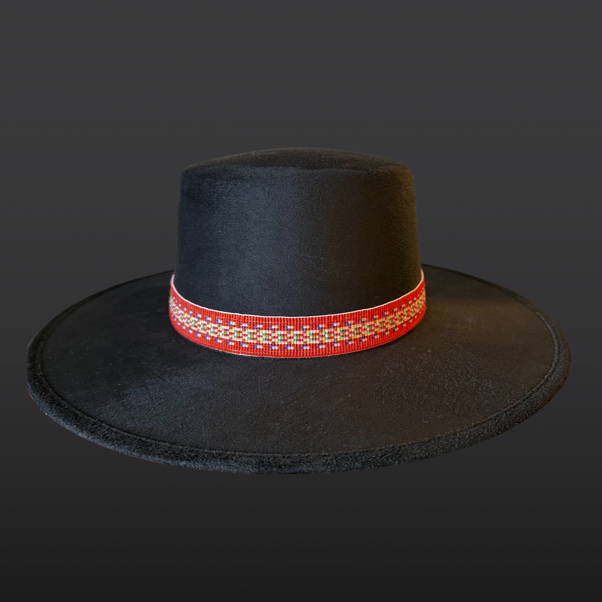 Black cordobés hat with Red River Métis beaded sash by Winnipeg Métis artist, honoring waterways, ancestry, and resilience / front view