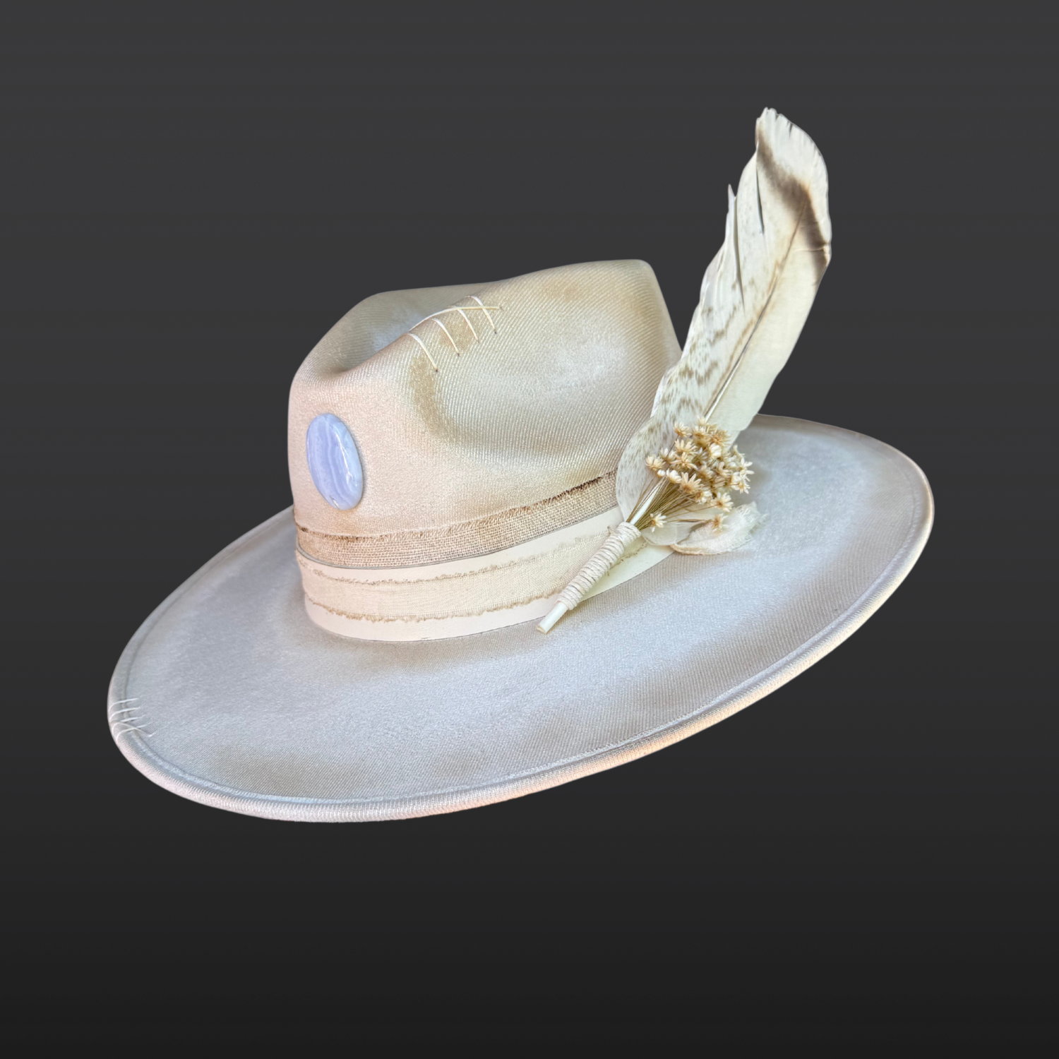 Lunar Bloom ivory wide brim fedora with blue lace agate crystal, ivory leather bands, hand embroidered details, and floral turkey feather.