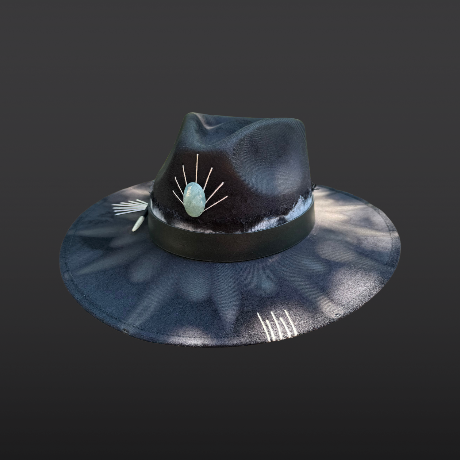 Front view of Ocean Within black wide brim fedora with aquamarine stone, black leather band, aqua and turquoise cotton band, turkey feather, and hand embroidered accents by Inara Hat Co.