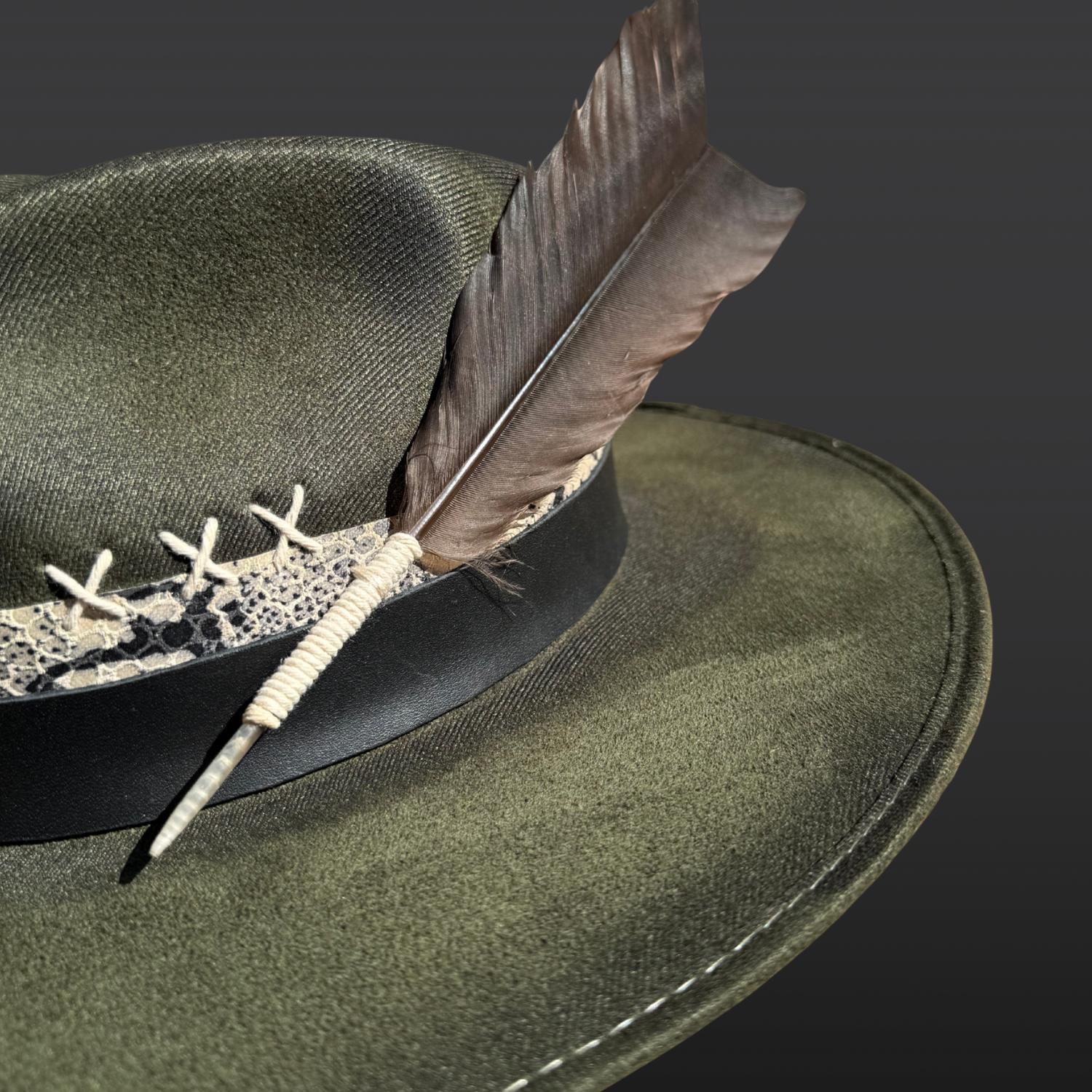 Close-up of turkey feather and embroidery accents on the Verdant Viper fedora.