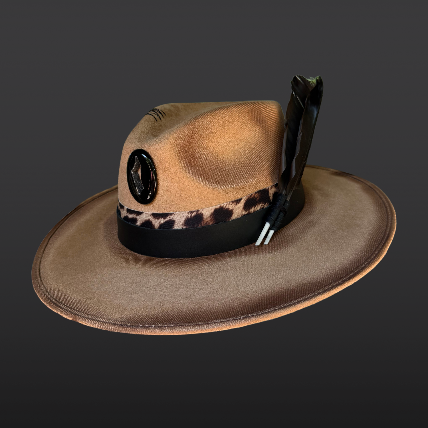 Camel wide-brim fedora featuring hand-burned artwork, black agate onyx druzy, crow feathers, and animal-print leather accents.