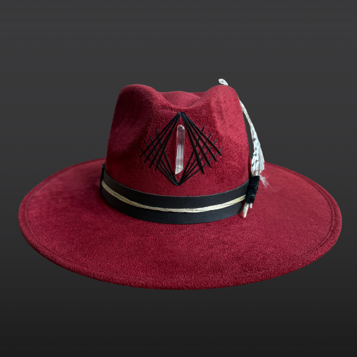 Artisan red wide brim fedora crafted from vegan suede with embroidered details, crystal accents, and feather embellishments.