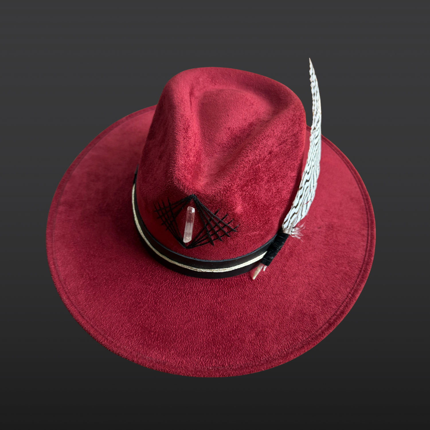 One-of-a-kind red vegan suede fedora with intricate embroidery, silver pheasant feather, and front-facing Lemurian quartz crystal.