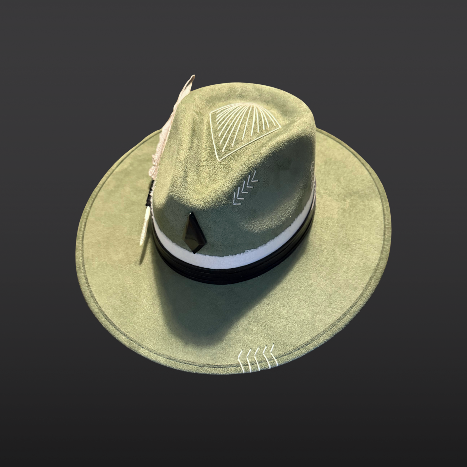 One of a kind sage green artisan fedora hat with obsidian stone, black leather band, white cotton wrap, feather detail, and hand embroidered directional symbols top view by Inara Hat Co.