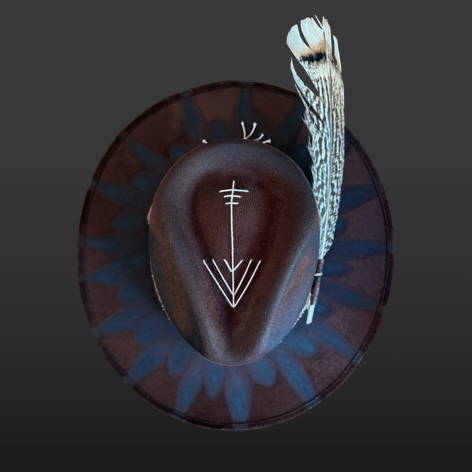 Top view of dark brown fedora hat highlighting wide brim shape, crown design, and hand-finished torch-burned details