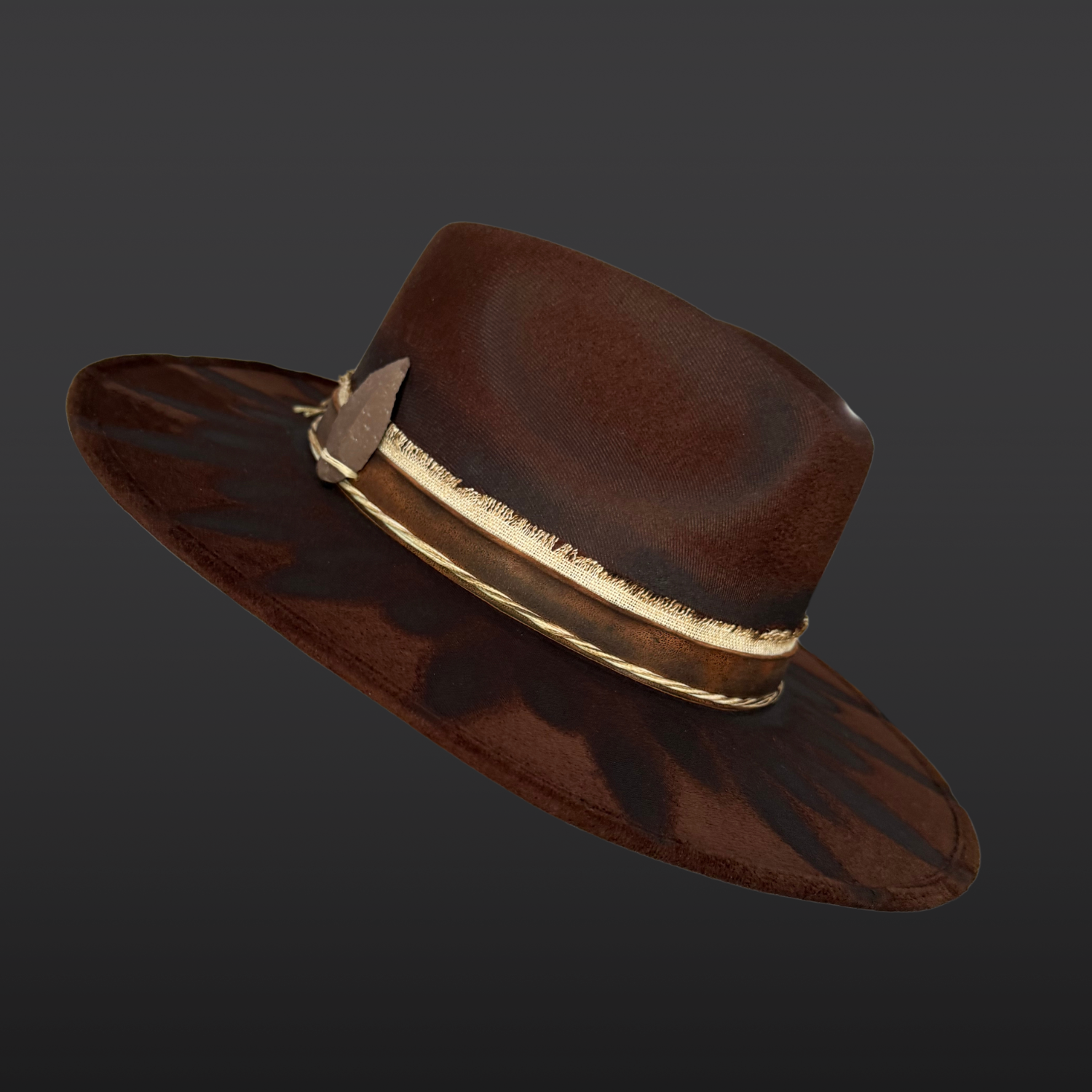 Angled Side profile of brown wide brim fedora hat showing feather embellishment, torch-burned detailing, and handcrafted boho design