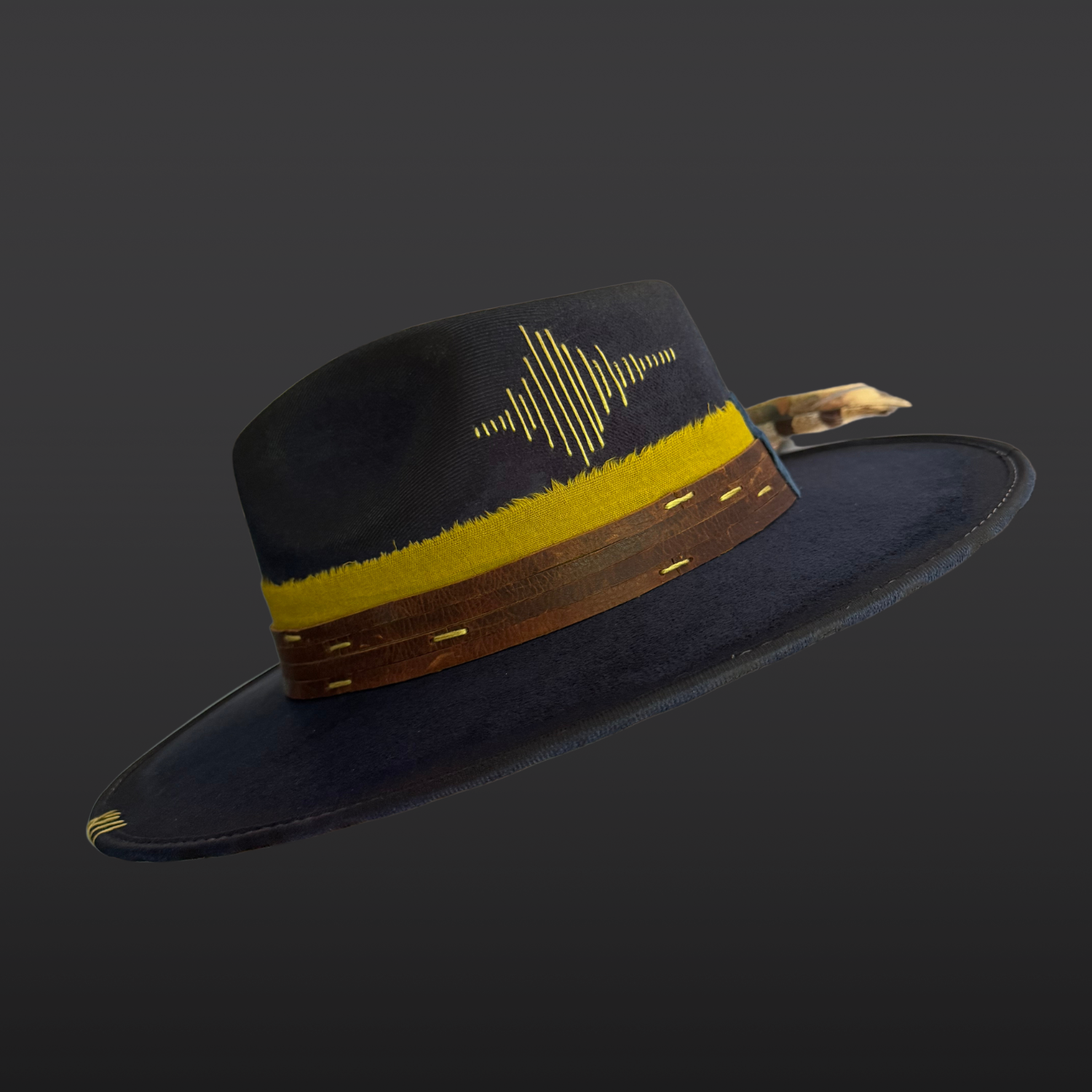 Side view of navy festival hat with hand-embroidered sound wave design and yellow stitching.