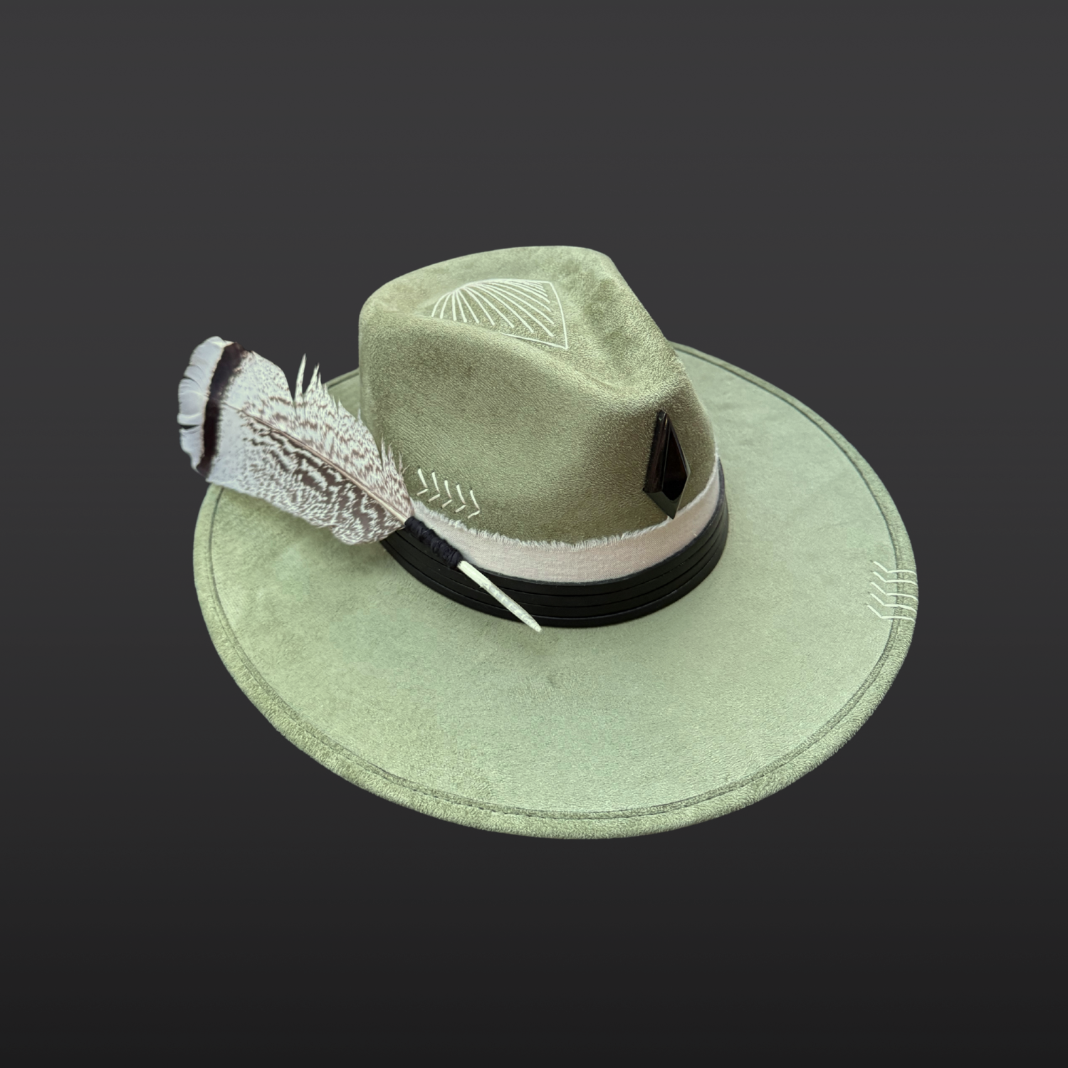 One of a kind sage green artisan fedora hat with obsidian stone, black leather band, white cotton wrap, feather detail, and hand embroidered directional symbols left view by Inara Hat Co.
