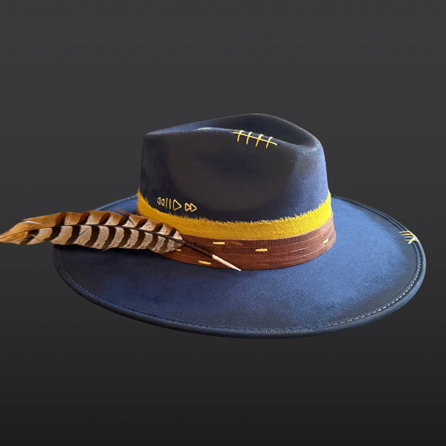 Front view of navy fedora hat featuring “Music Is Life” embroidery and a vibrant yellow band.