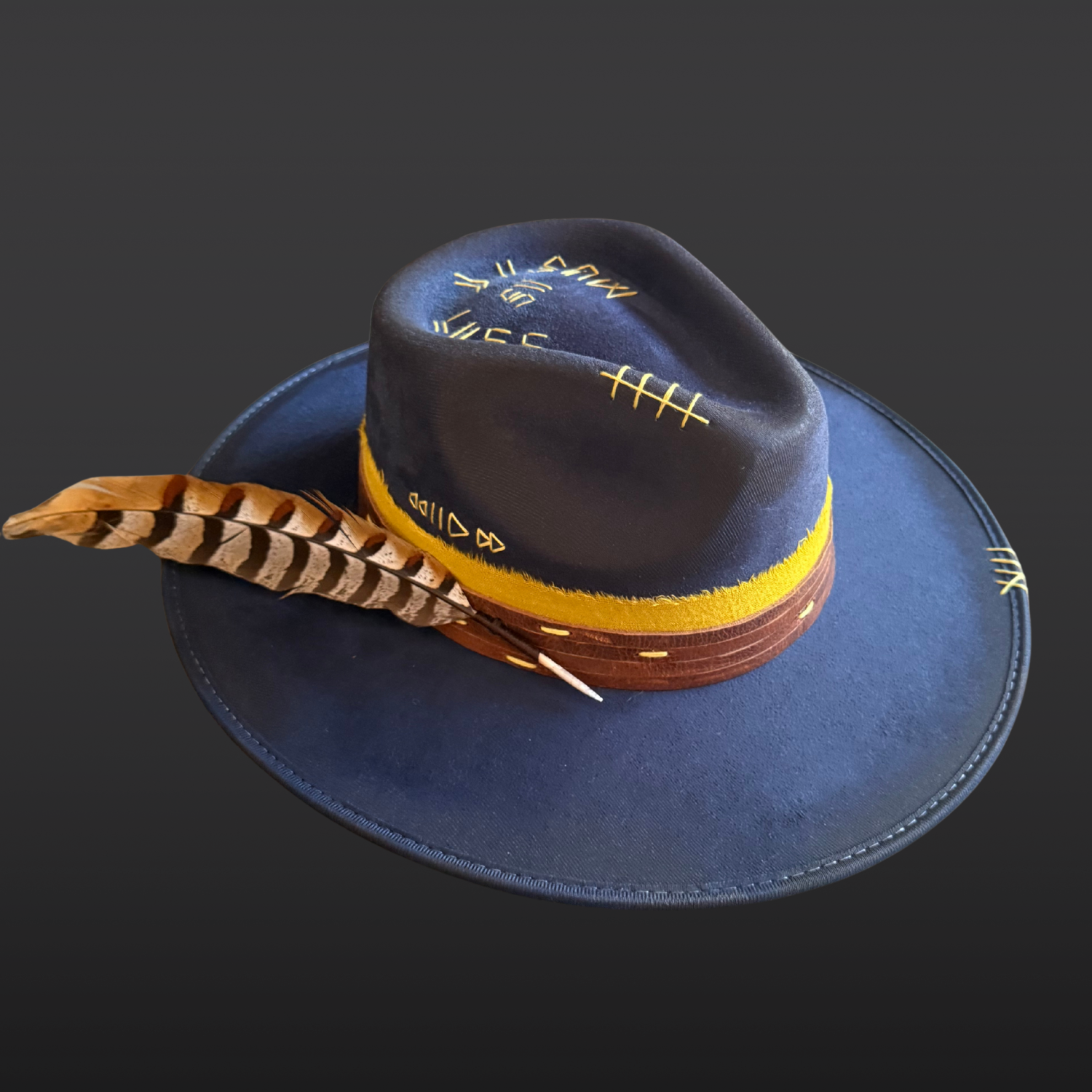 Navy wide brim fedora hat with yellow cotton band, hand-embroidered music details, and pheasant feather.