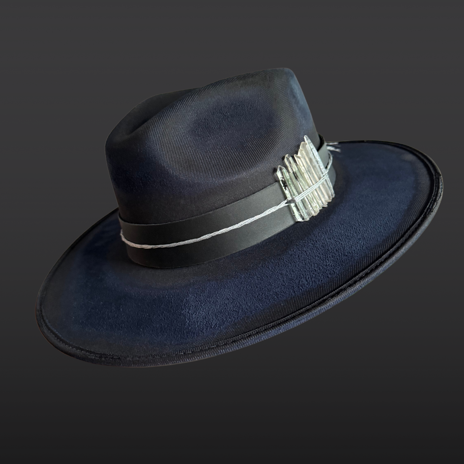 Celestial Alignment Fedora Hat in navy vegan suede featuring quartz crystals, silver embroidery, black leather band, and celestial-inspired details.