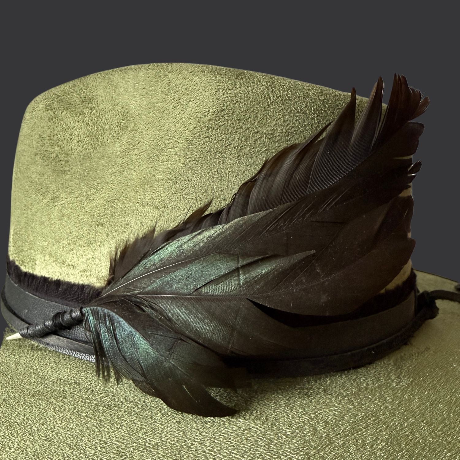 sage green boho fedora hat with arrow embroidery and obsidian arrow / rooster feather close up