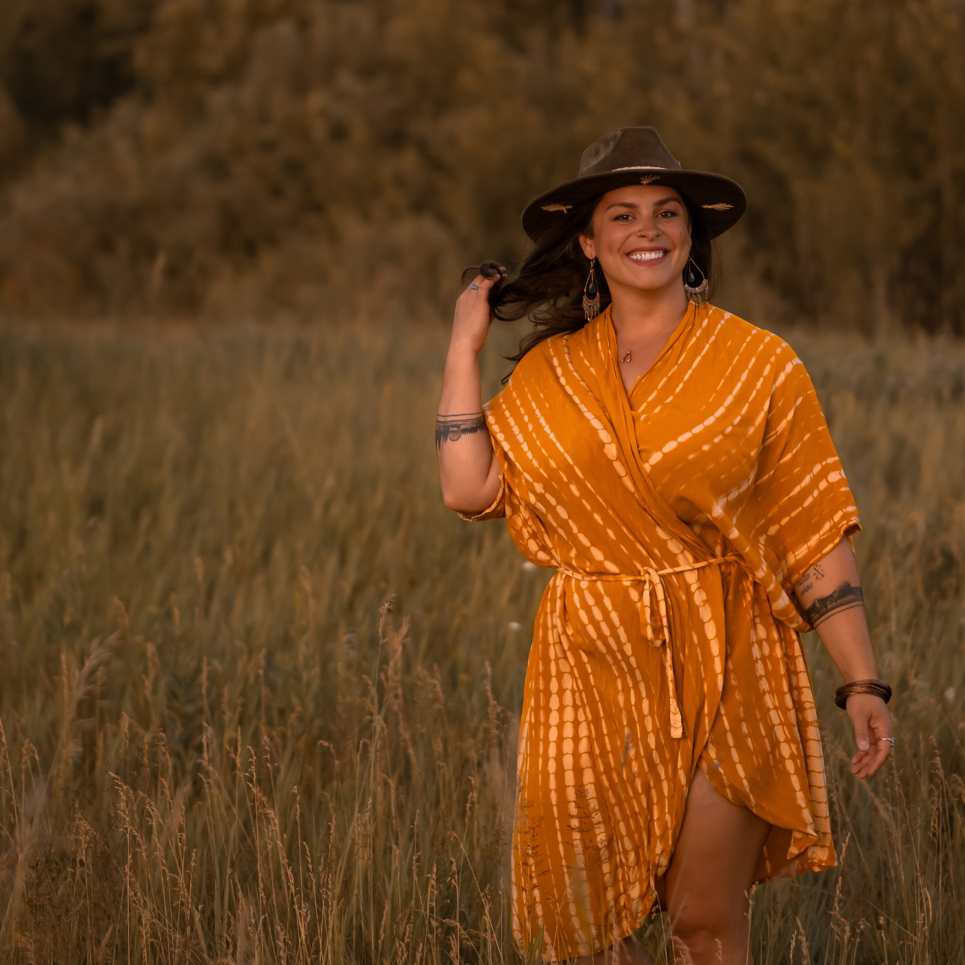 Woman wearing an ethically designed boho statement hat by Inara Hat Co., inspired by nature and personal expression.