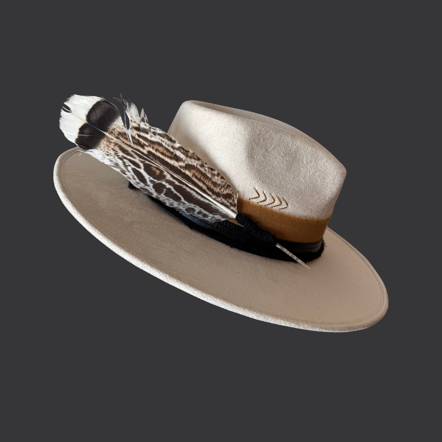 Left Side view of ivory boho fedora with black leather band, burnt orange cotton wrap, and turkey feather