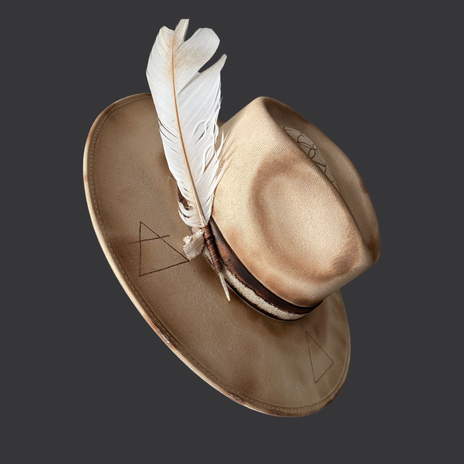Cream wide-brim vegan suede fedora with Seed of Life and Four Elements pyrography, brown leather band, feather, and crystal arrow / left side view