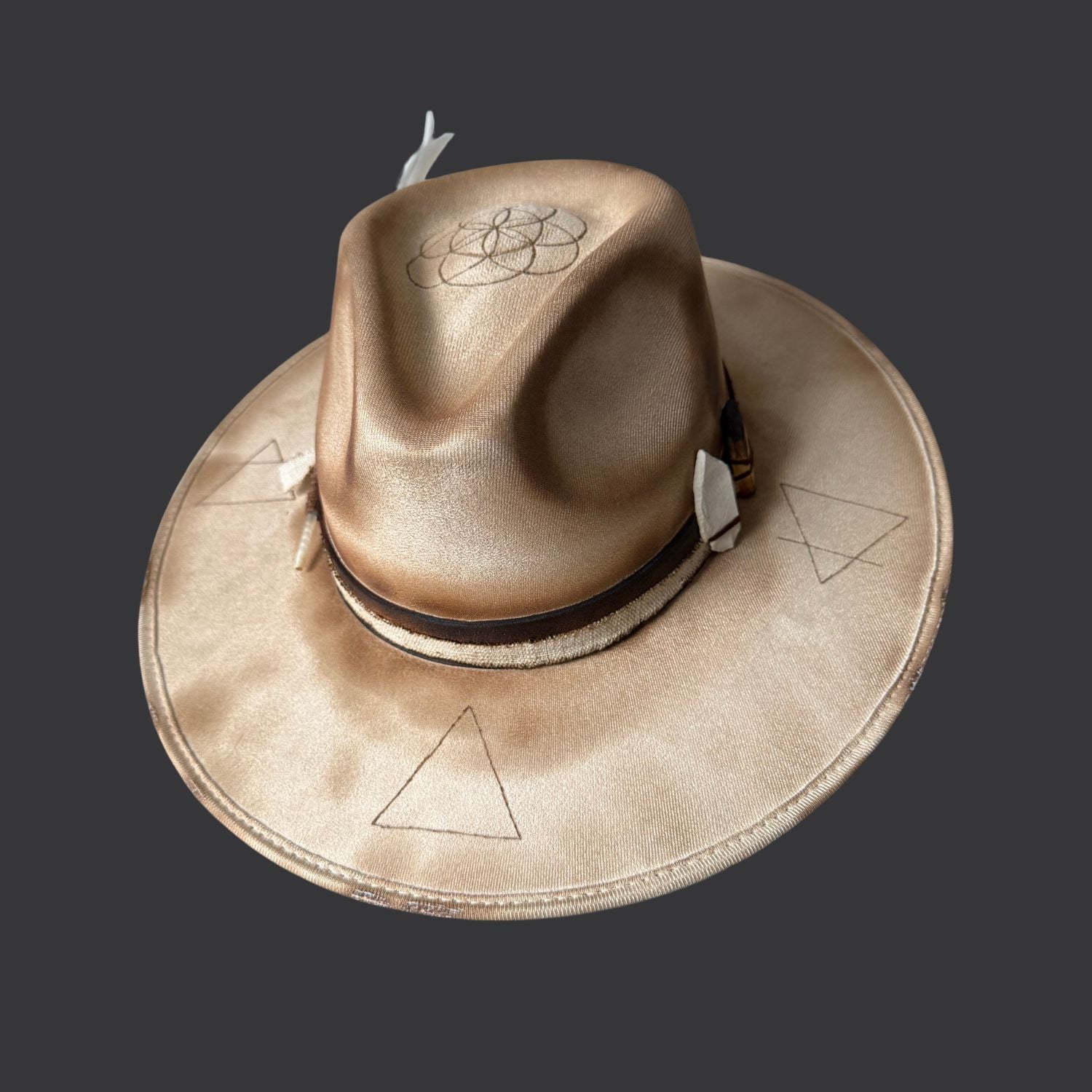 Cream wide-brim vegan suede fedora with Seed of Life and Four Elements pyrography, brown leather band, feather, and crystal arrow / front view