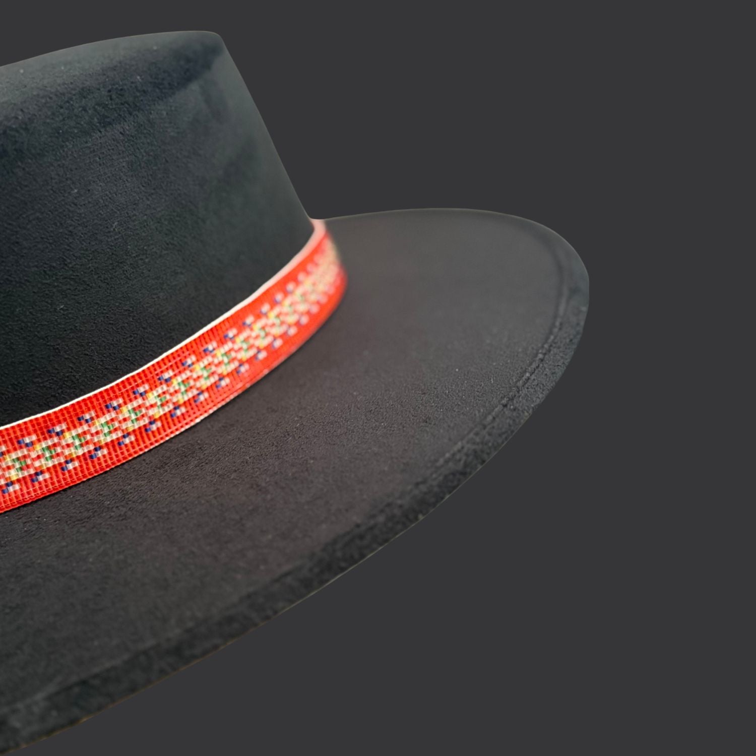Black cordobés hat with Red River Métis beaded sash by Winnipeg Métis artist, honoring waterways, ancestry, and resilience / side view
