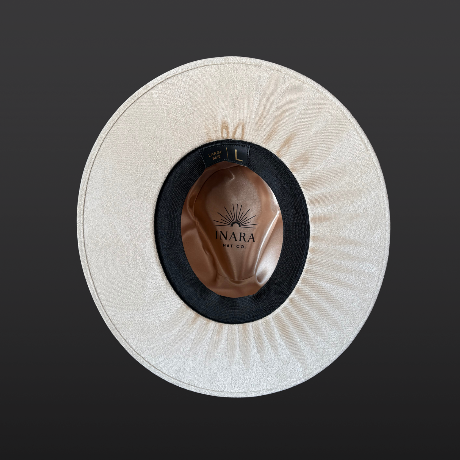 Under brim  view of ivory wide-brim fedora hat with sunburst embroidery, Lemurian quartz, obsidian arrow, leather band and feather detail