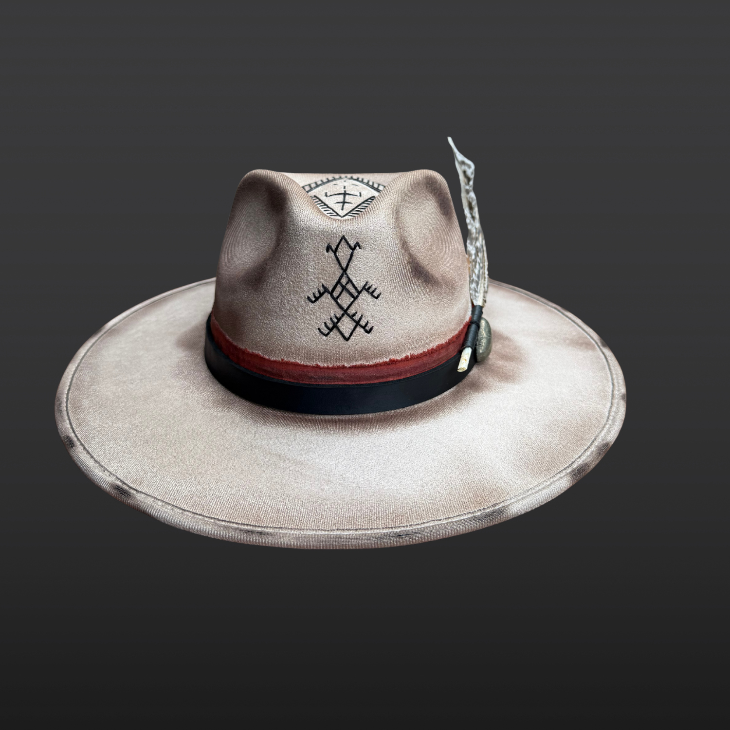Front view of Ember Guardian khaki fedora hat with hand-embroidered black detailing and rust red band layered with black leather.
