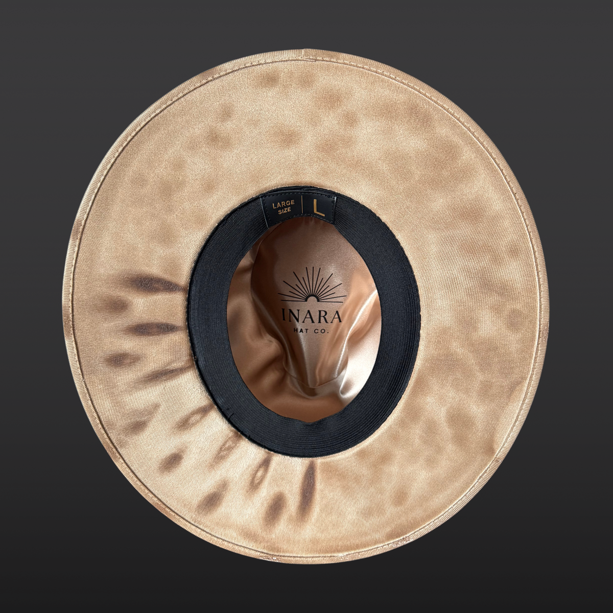 Under-brim view of Elemental Harmony cream fedora showing detailed fire burned marks to frame the face