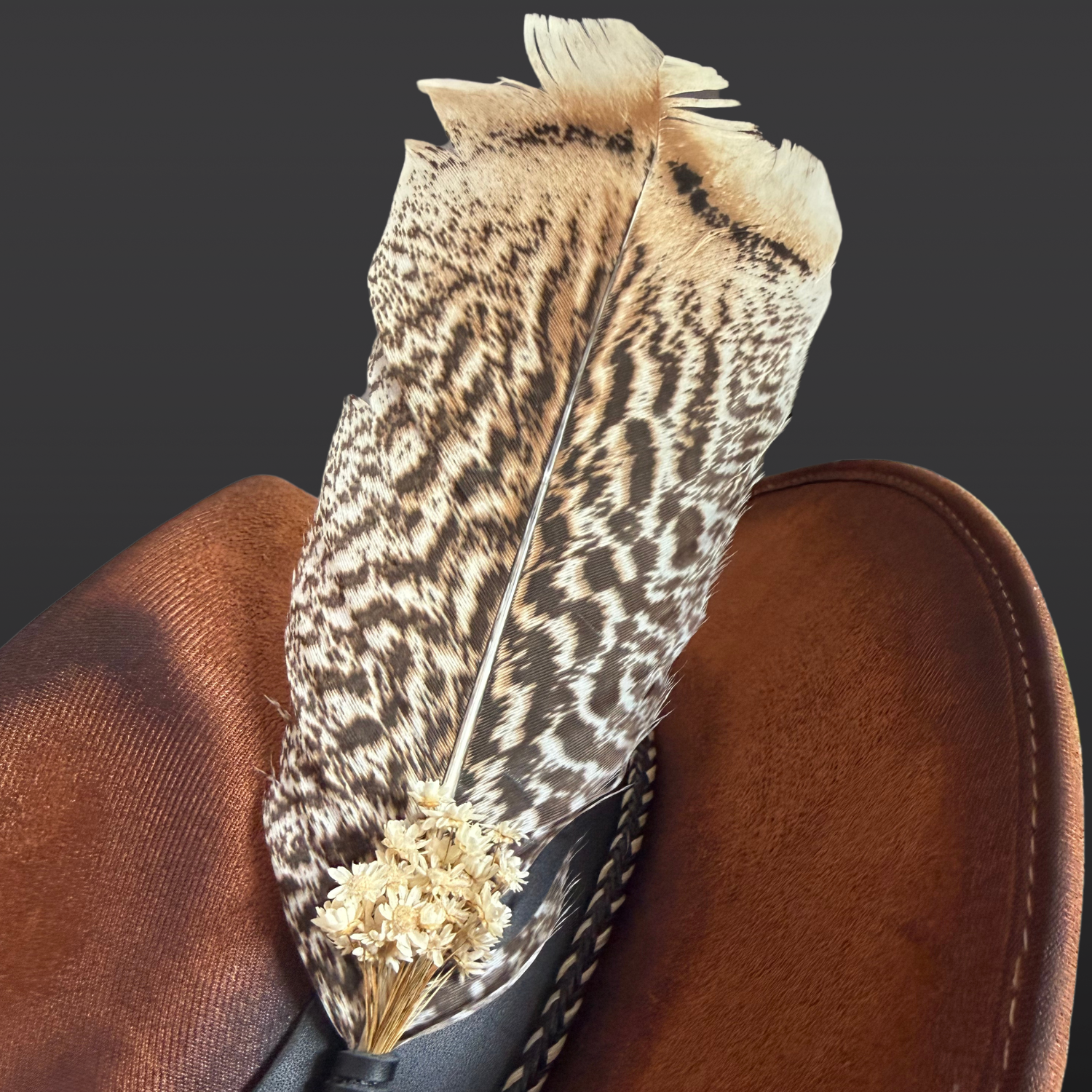Close-up of turkey feather with ivory dried flowers on Wild in the Woods boho fedora hat