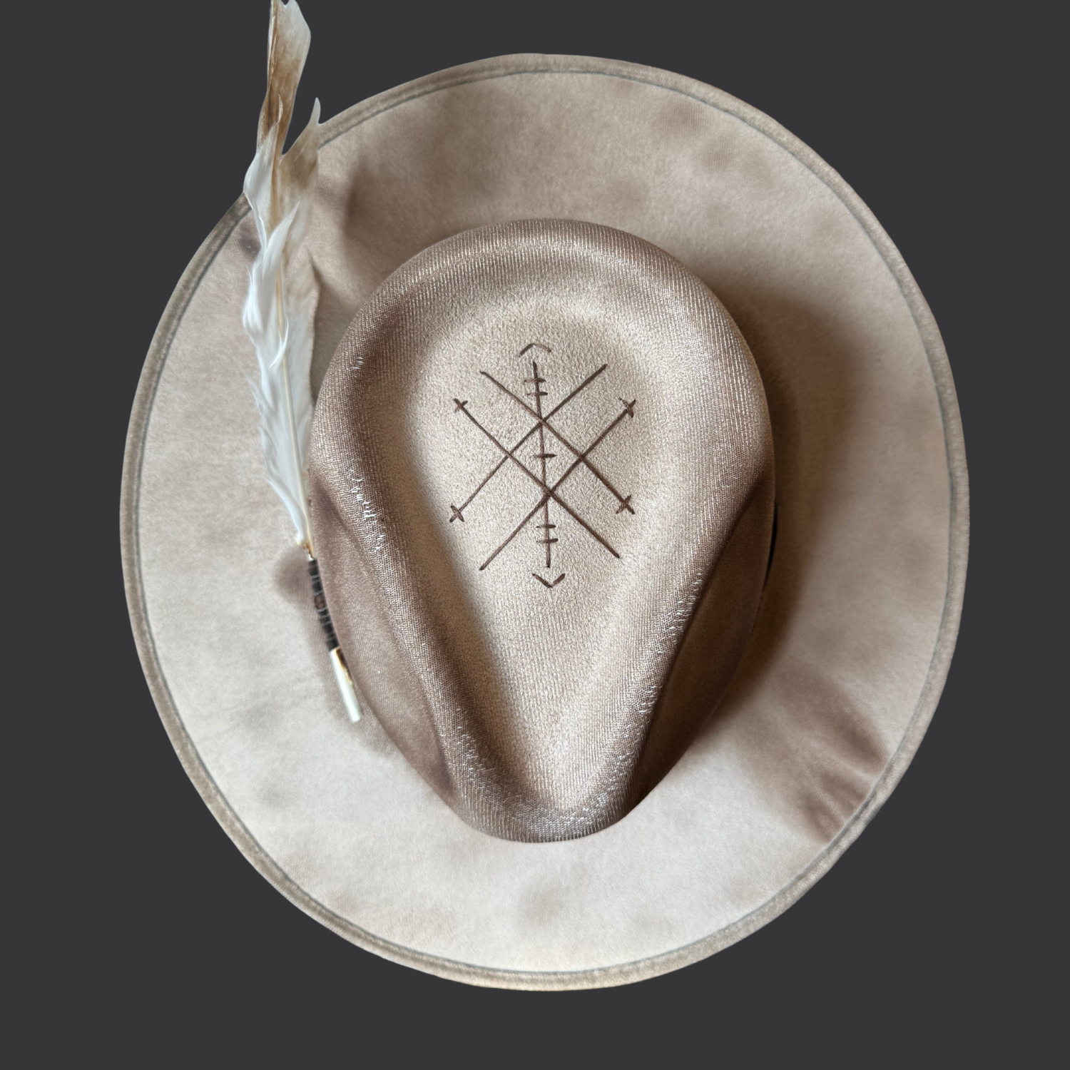 Top view of khaki fedora hat with pyrography detailing and pyrite accent