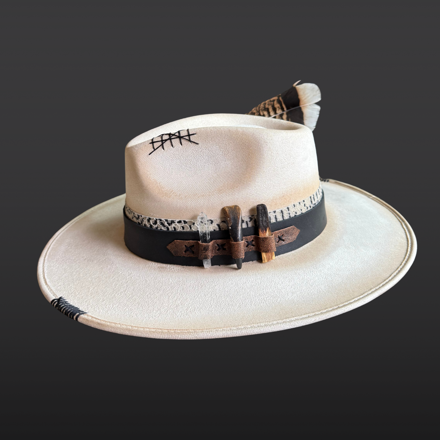 Right side view of Unbound ivory wide brim fedora hat featuring black embroidered details and a rugged hand-torched finish.