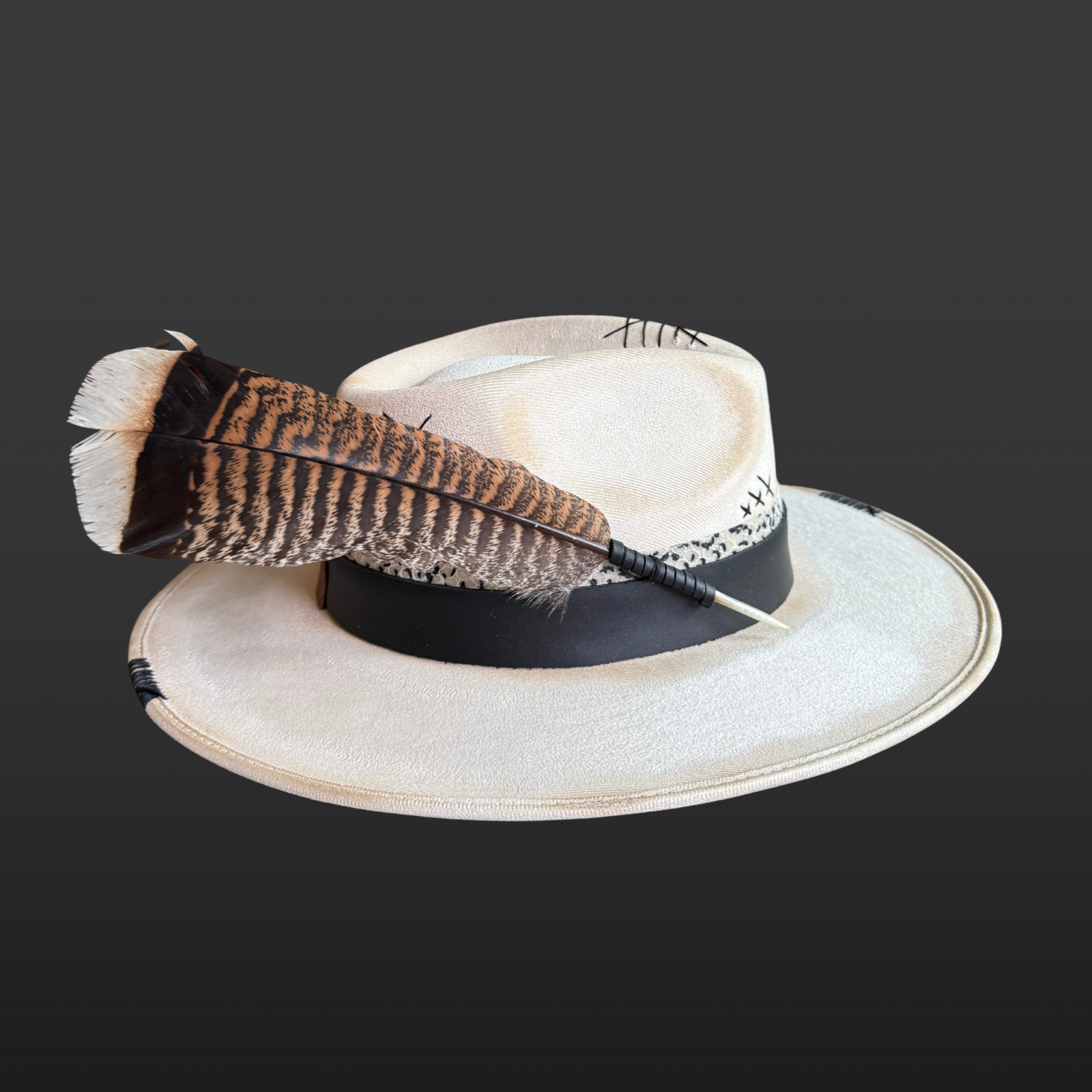 Alternate left side view of Unbound ivory wide brim fedora hat featuring black embroidered details and a rugged hand-torched finish.