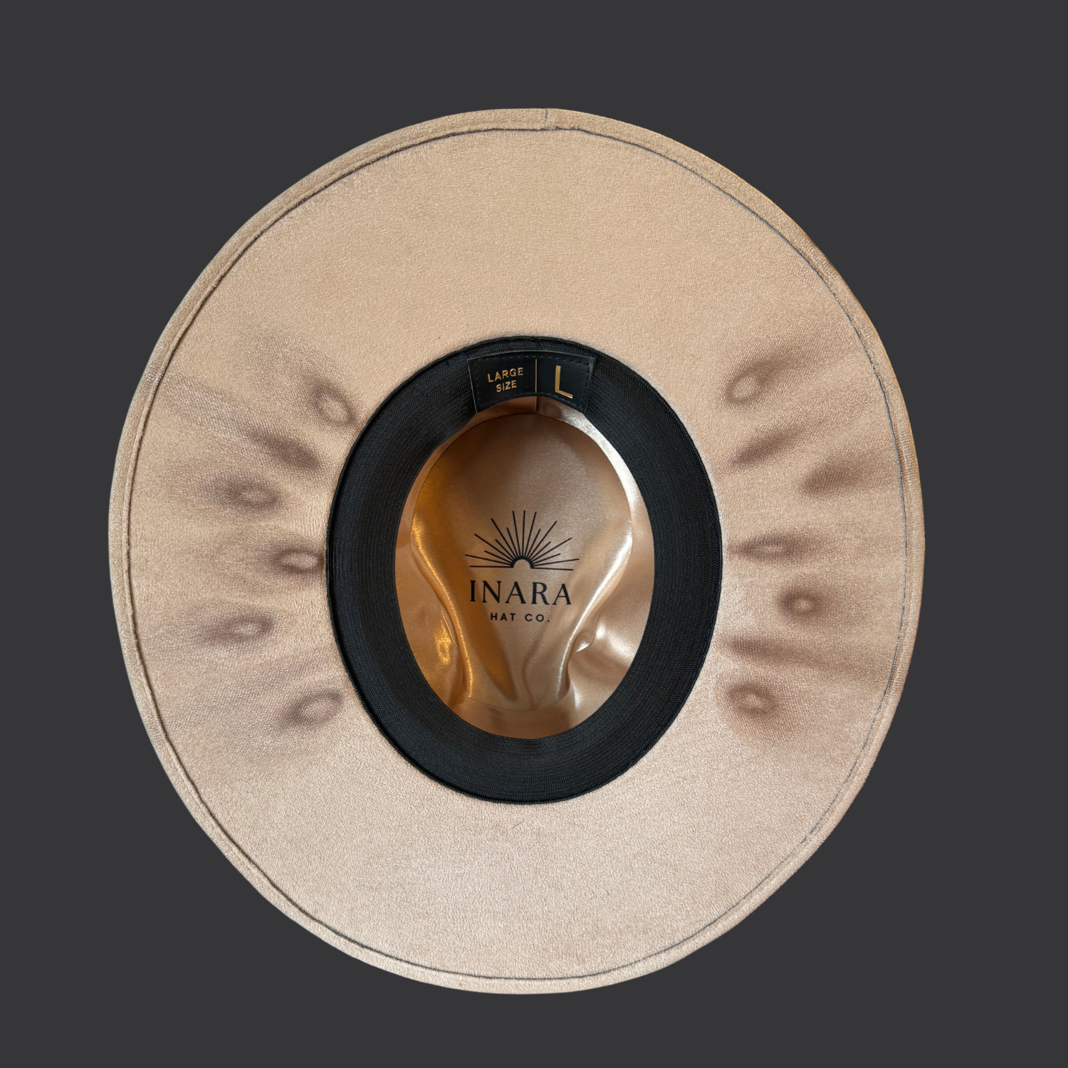 Bottom brim view of khaki fedora hat with pyrography detailing and pyrite accent