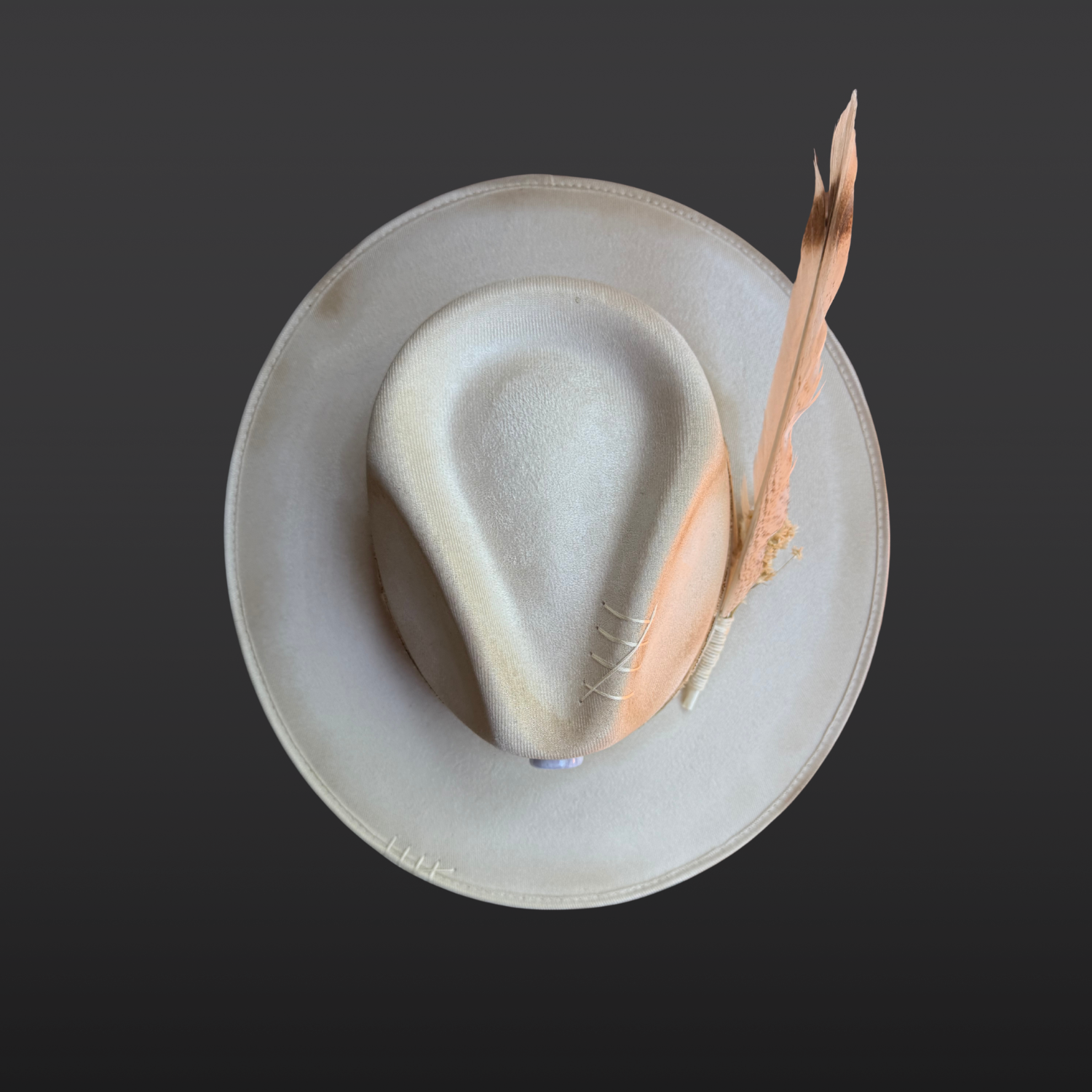 Top view of ivory wide brim fedora showing layered leather bands and handcrafted crown details.