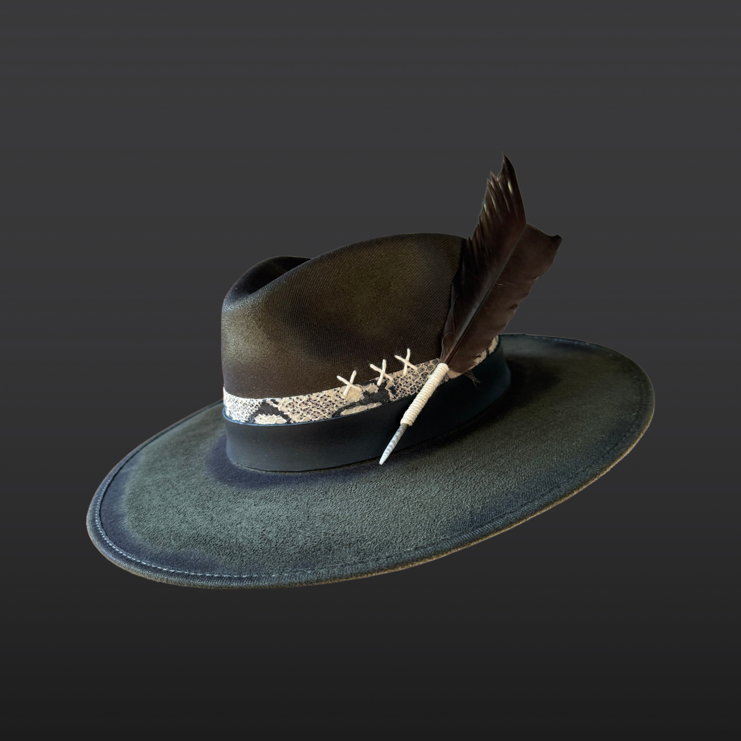 Side view of the Verdant Viper fedora showcasing layered black and serpent-print leather bands with green kyanite, Lemurian quartz, and deer antler details.