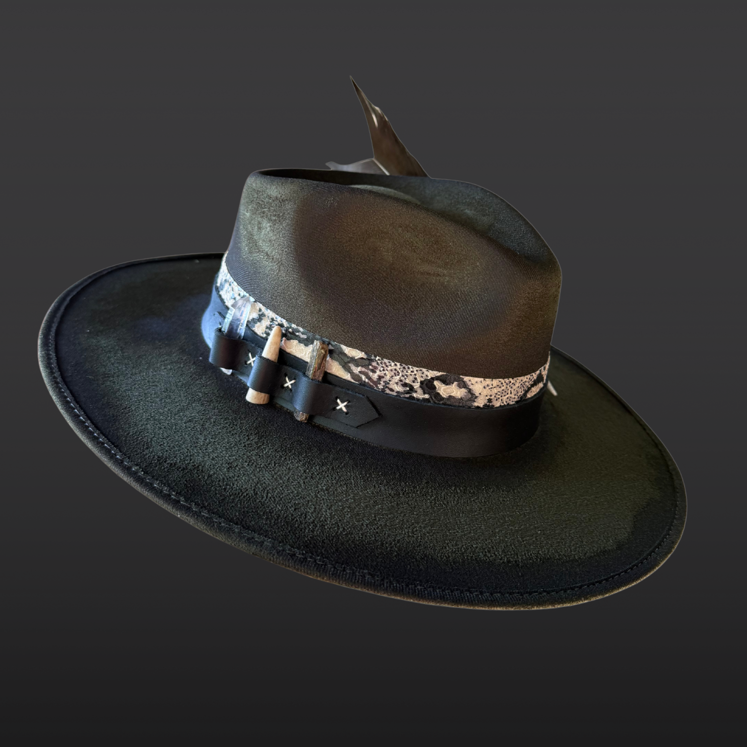 Angled side view of the Verdant Viper fedora showcasing layered black and serpent-print leather bands with green kyanite, Lemurian quartz, and deer antler details.
