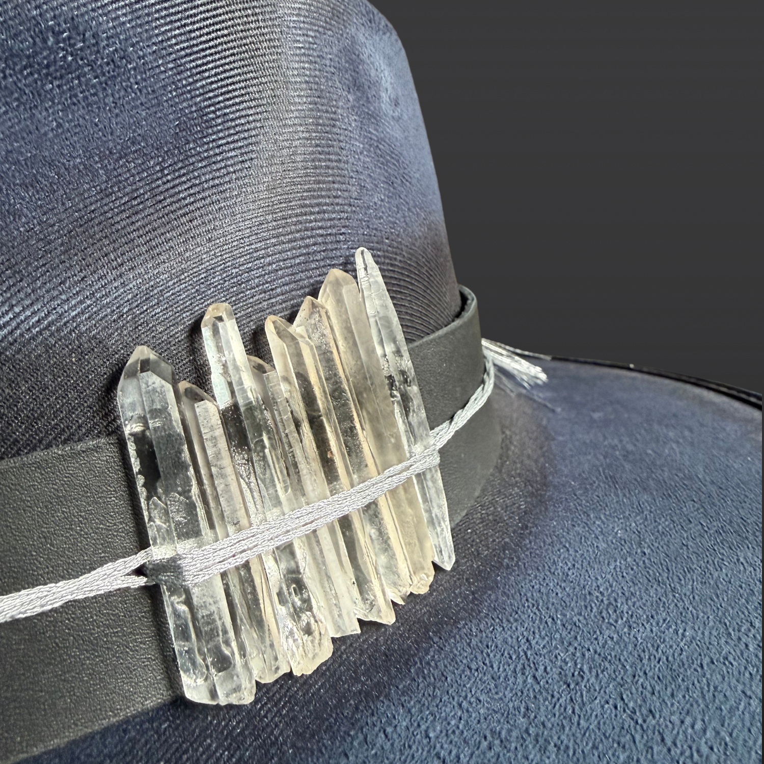 Close-up of eight quartz crystal points arranged on the Celestial Alignment Fedora Hat with silver celestial accents.