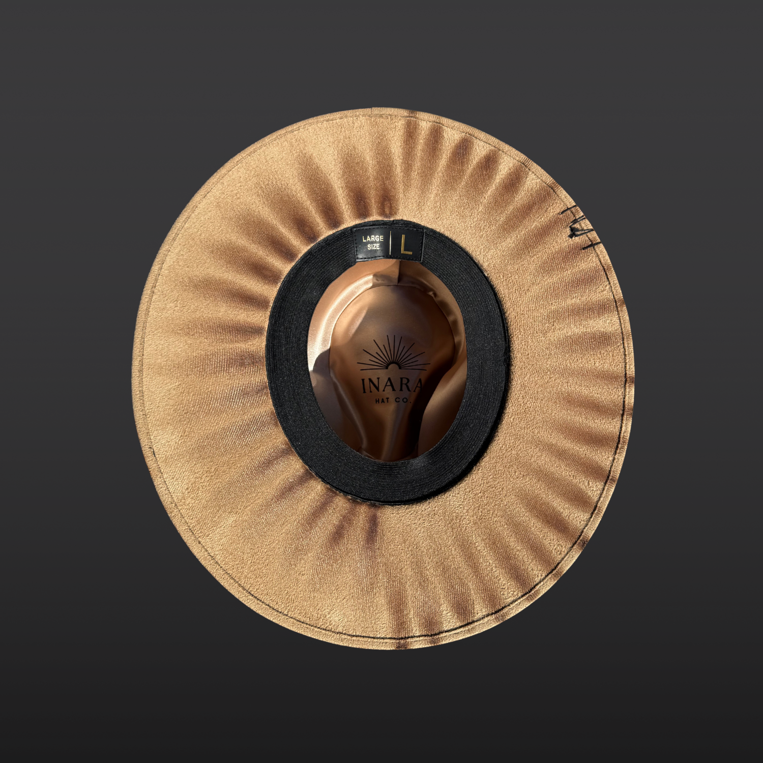 Close-up of the underside brim featuring hand-burned artwork designed to frame the face.