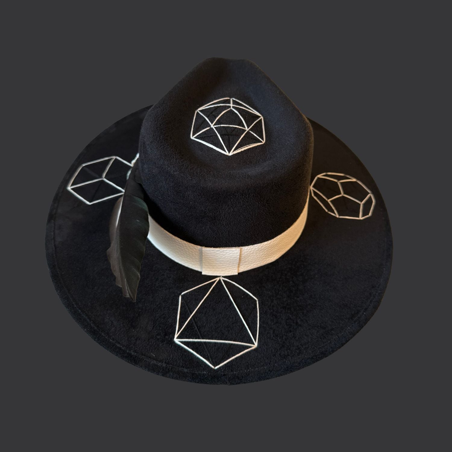 Black suede wide brim fedora with tree agate crystal, white leather band, and green black white duck feather / back view
