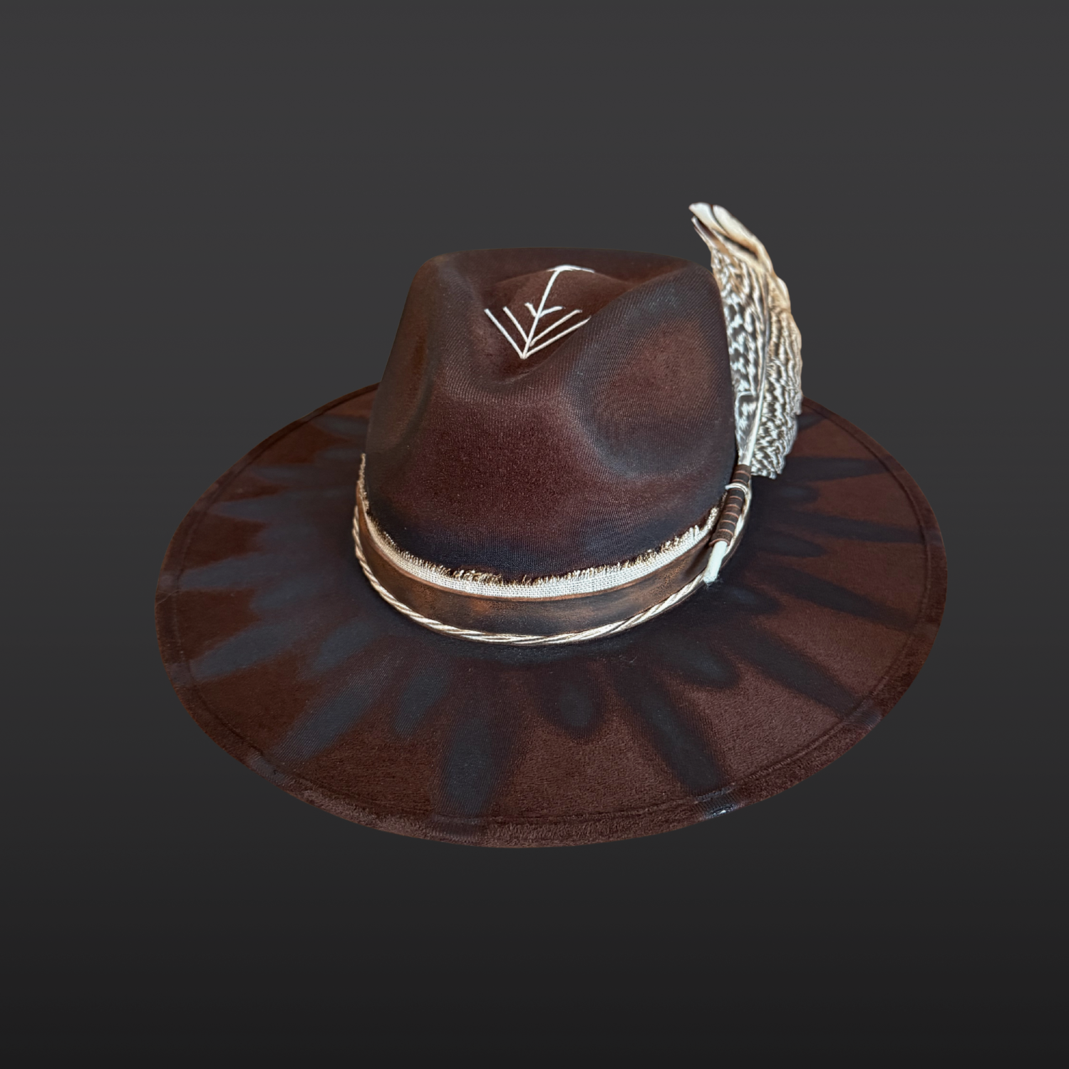 Front view of dark brown vegan suede wide brim fedora hat featuring hand-embroidered arrow design and stone arrow adornment