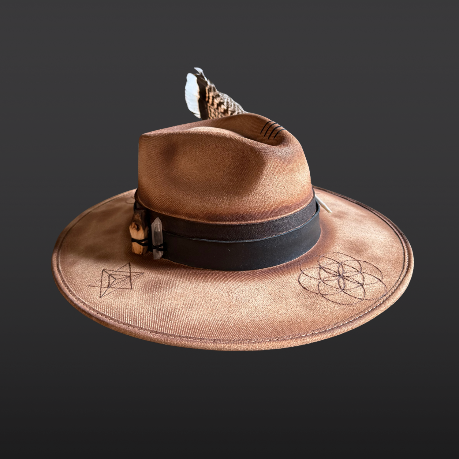 Left side view of camel wide brim fedora with Palo Santo, Clear Quartz, turkey feather, and distressed leather bands